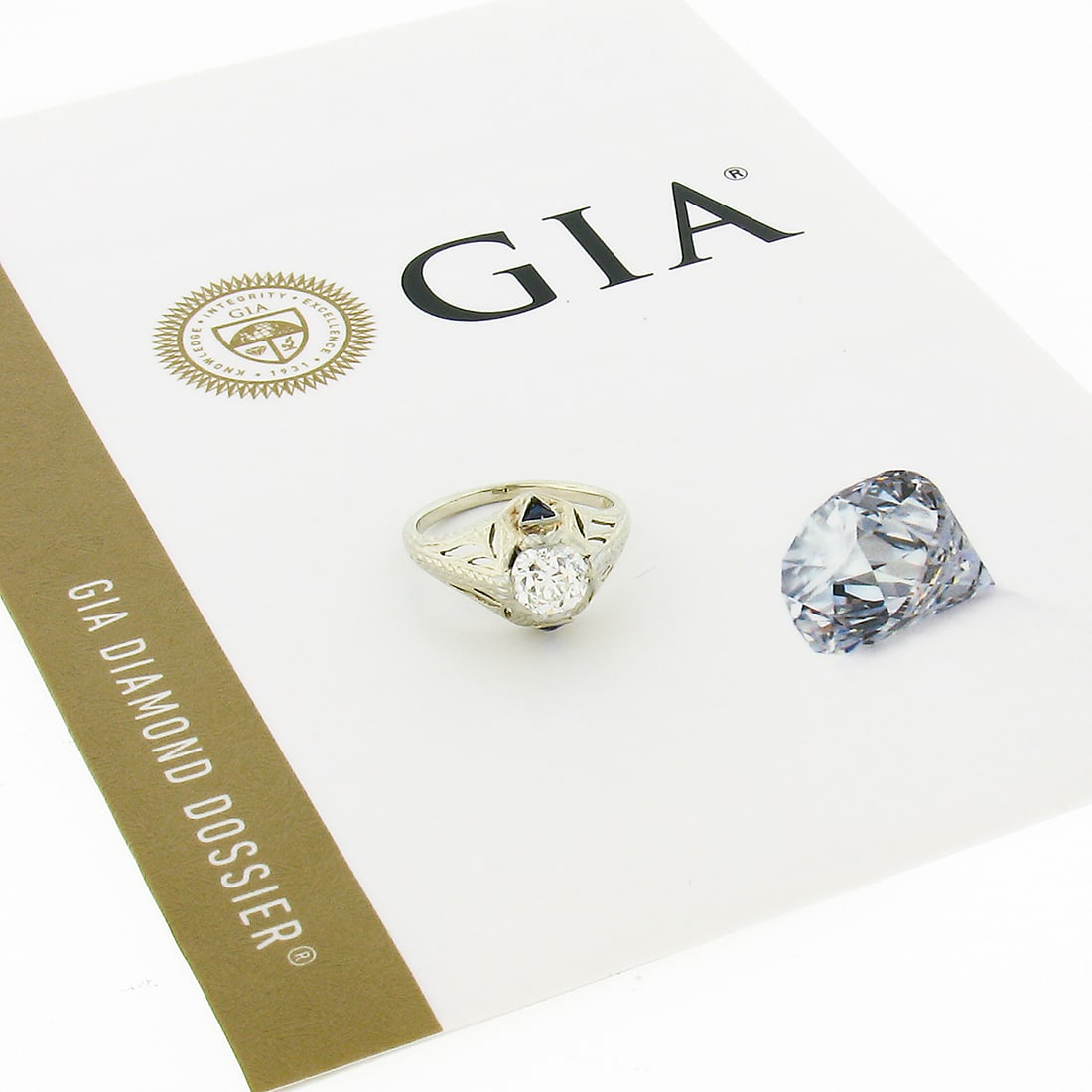 Antique Art Deco 18k Gold GIA Certified Diamond Sapphire Engagement Ring: Antique Art Deco 18k Gold GIA Certified Diamond Sapphire Engagement Ring This exquisite antique Art Deco engagement ring showcases a stunning 0.84 carat GIA-certified Old European cut diamond, prong s