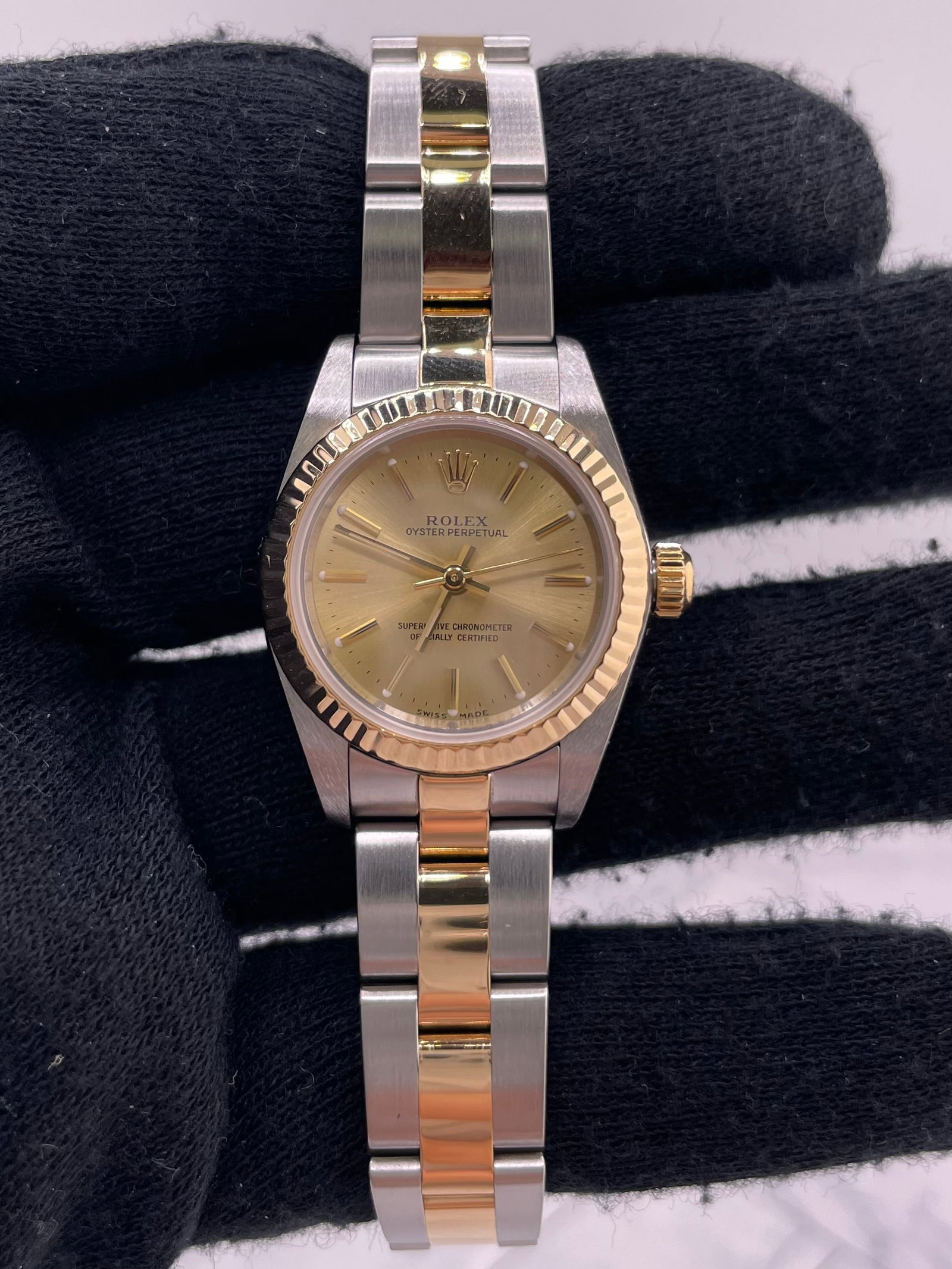 Ladies Rolex Oyster Perpetual Champagne Dial Fluted Bezel Ref 76193: Ladies Rolex Oyster Perpetual Champagne Dial Fluted Bezel Ref 76193 This Rolex Oyster Perpetual watch features a champagne dial, fluted bezel, and an Oyster bracelet. Designed for ladies, it is part o