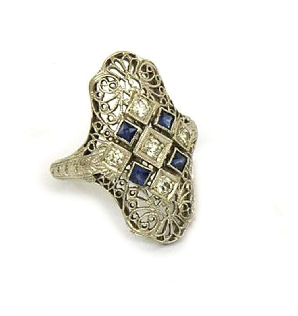 Art Deco 18k White Gold Sapphire Diamond Filigree Ring Size 6: Art Deco 18k White Gold Sapphire Diamond Filigree Ring Size 6 This Art Deco filigree ring is crafted from 18k white gold and features a striking square-cut sapphire accented by round-cut diamonds. The
