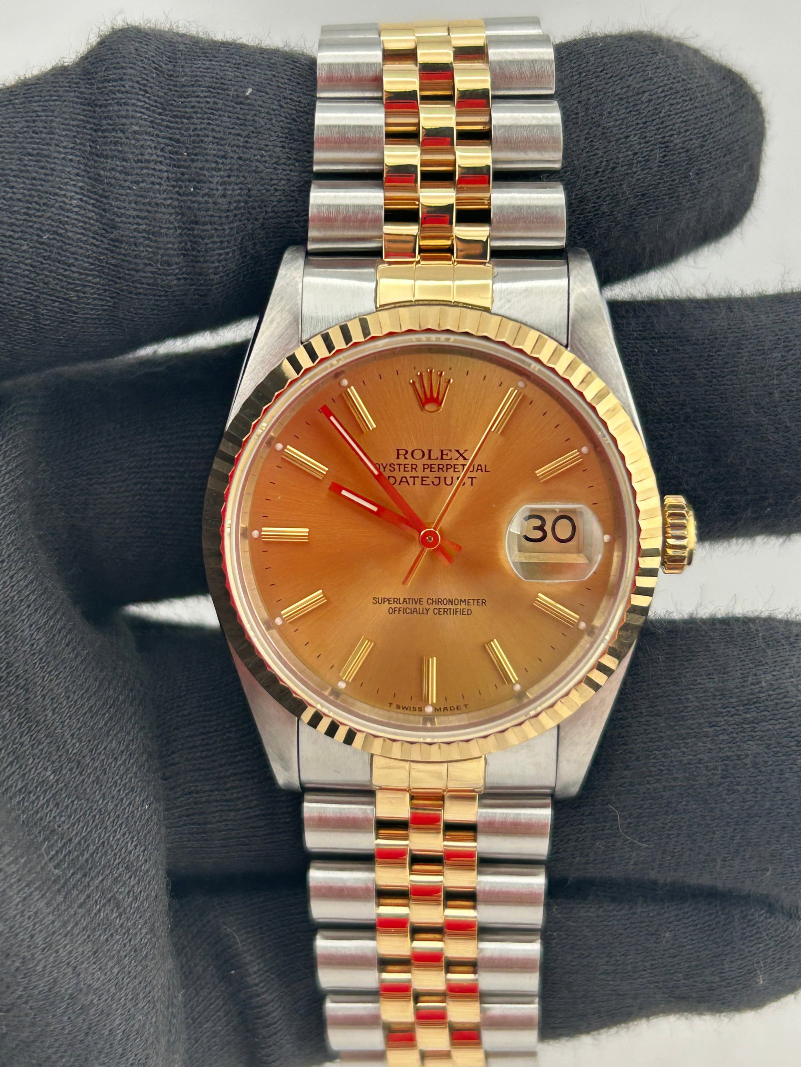 Rolex Datejust 16233 Champagne Dial Jubilee Papers 1996: Rolex Datejust 16233 Champagne Dial Jubilee Papers 1996 This Rolex Datejust features a champagne stick dial and is paired with a D-Link Jubilee bracelet. The watch has a fluted bezel and comes with pa