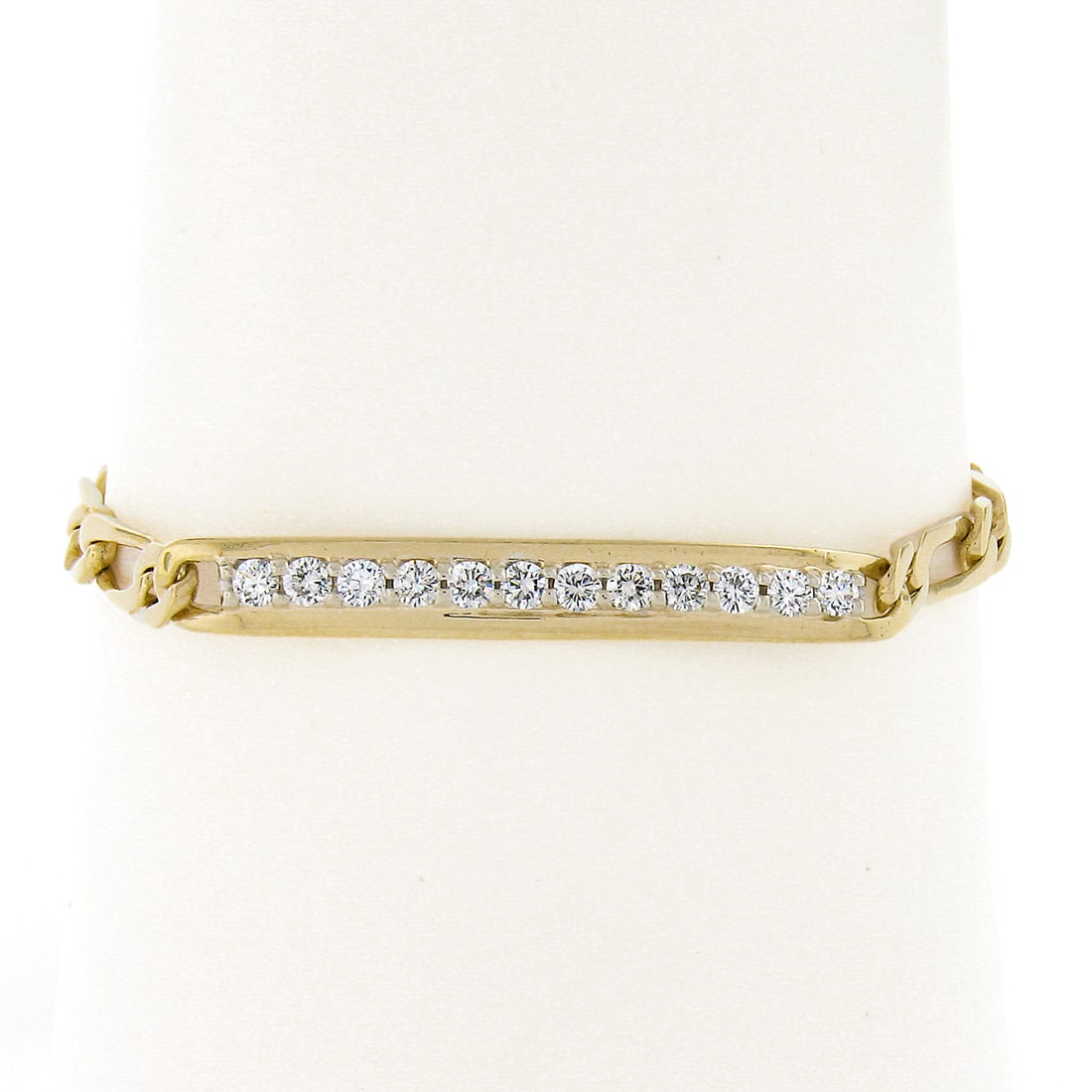 14k Yellow Gold Figaro ID Bracelet with 12 Diamonds 6.75 in: 14k Yellow Gold Figaro ID Bracelet with 12 Diamonds 6.75 in Estate unisex ID-style Figaro link chain bracelet crafted in solid 14k yellow gold and set with natural diamonds. The center ID plaque is ac