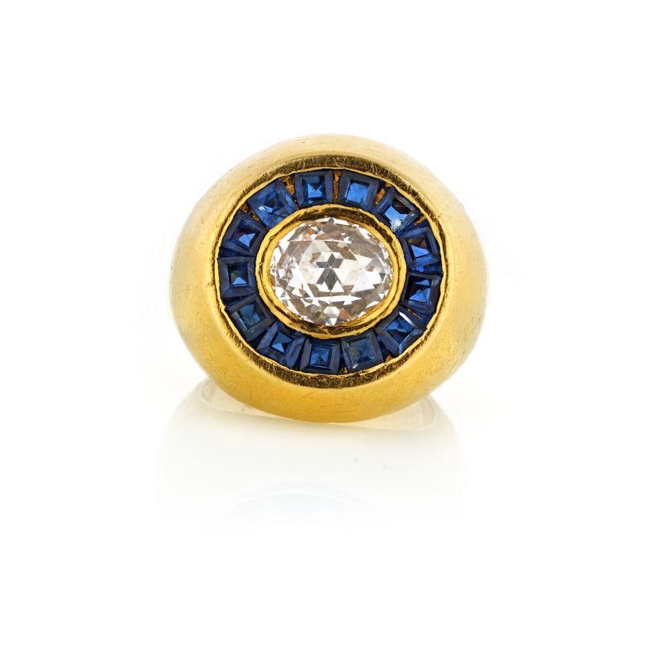 GYPSY 18K Yellow Gold Rose Cut Diamond and Sapphire Cocktail Ring: GYPSY 18K Yellow Gold Rose Cut Diamond and Sapphire Cocktail Ring This exquisite estate ring showcases a stunning oval rose cut diamond at its center, weighing 1.25 cts. The diamond is beautifully sur