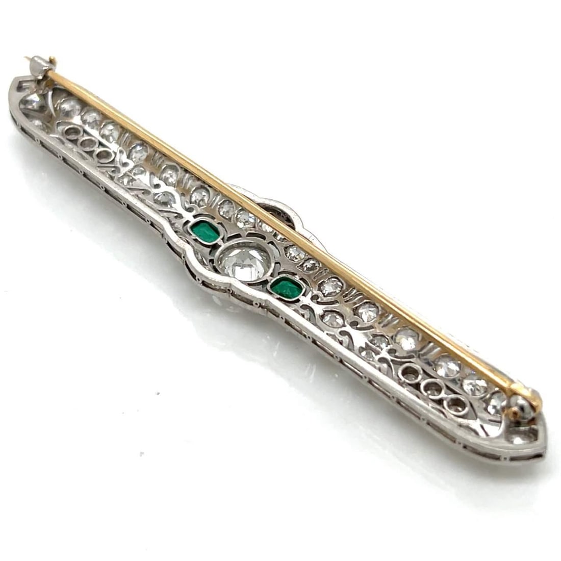 Art Deco Platinum Brooch with 1.25 Ct Diamond and Emeralds: Art Deco Platinum Brooch with 1.25 Ct Diamond and Emeralds This exquisite Art Deco brooch showcases a stunning combination of platinum, diamonds, and emeralds. At its center, a brilliant approximately