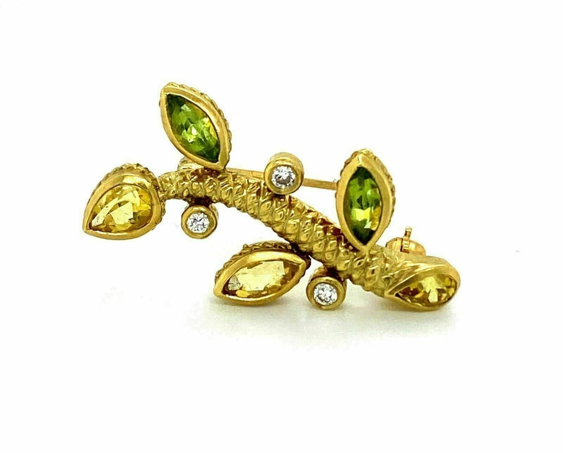 Judith Ripka 18k Yellow Gold Leaf Brooch with Diamond Peridot Citrine: Judith Ripka 18k Yellow Gold Leaf Brooch with Diamond Peridot Citrine This Judith Ripka brooch is crafted in 18k yellow gold and features a leaf stem design accented with diamonds, peridot, and citrin