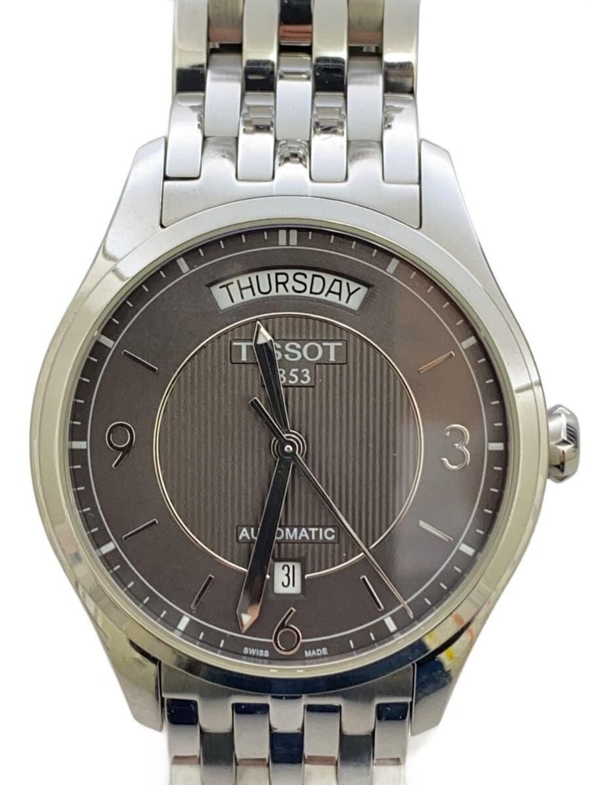 Tissot T-One Gray Men's Swiss Wristwatch: Tissot T-One Gray Men's Swiss Wristwatch This TISSOT T-one men's wristwatch features a gray design and is crafted in Switzerland. The watch is pre-owned and graded B, indicating slight signs of use. I