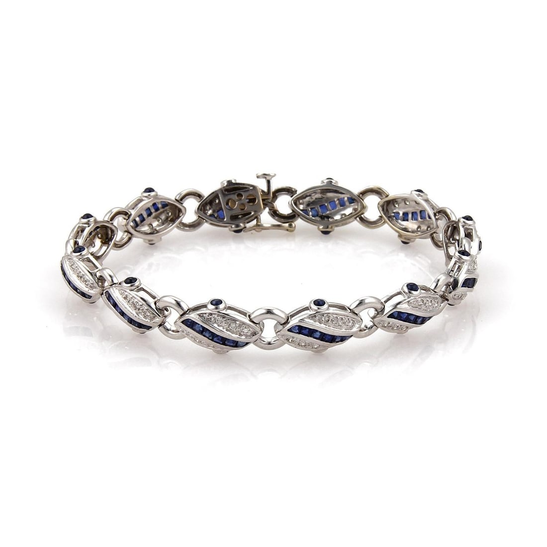 Estate 3.35ct Diamond 18k White Gold Bracelet with Blue Stones: Estate 3.35ct Diamond 18k White Gold Bracelet with Blue Stones This exquisite estate bracelet is designed in 18k white gold featuring a polished finish, showcasing 12 elegant shell-shaped links. The c