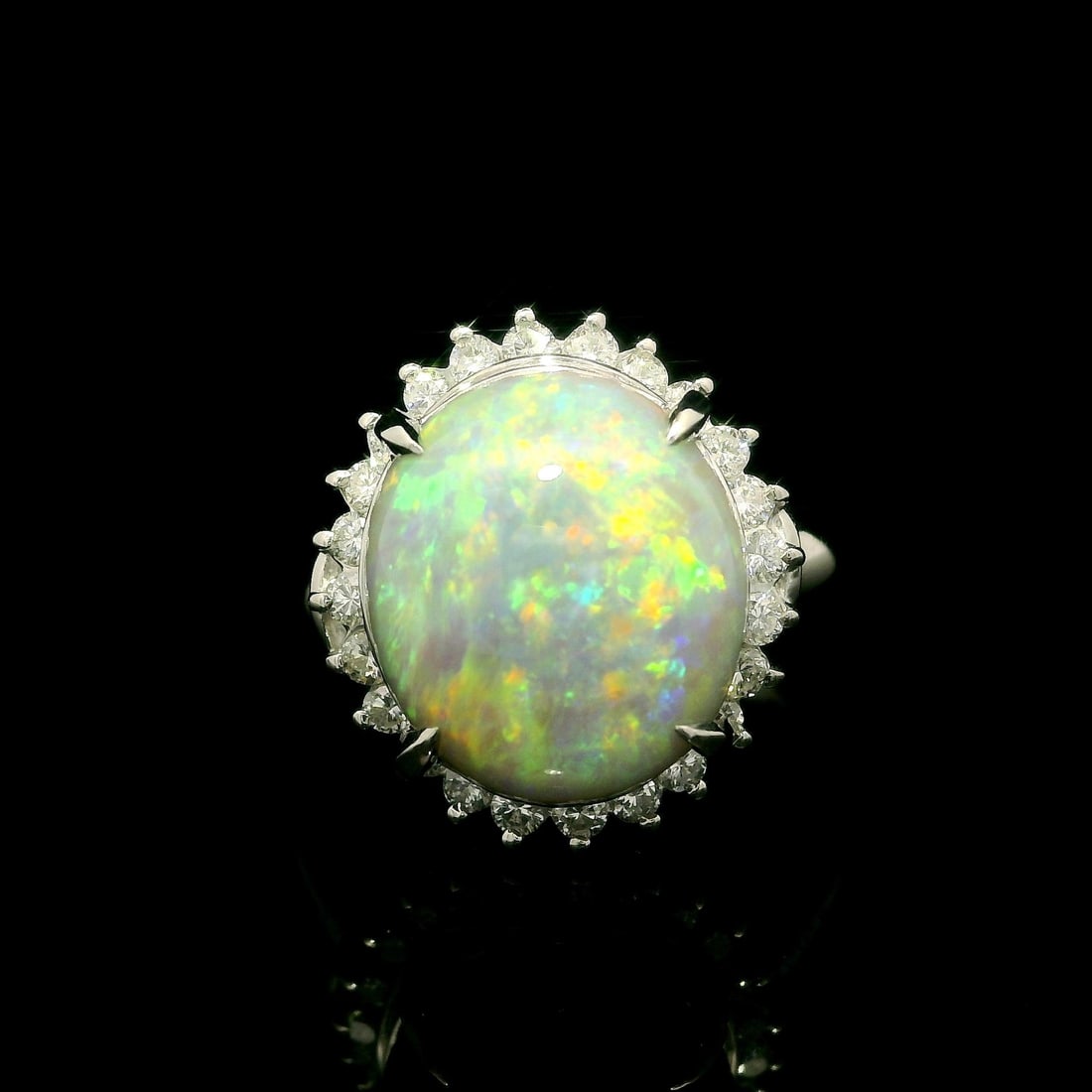 Platinum 5.04ctw Opal Diamond Halo Cocktail Ring: Platinum 5.04ctw Opal Diamond Halo Cocktail Ring This stunning cocktail ring features a captivating 5.04 carat total weight, showcasing a natural oval opal at its center, known for its beautiful play 