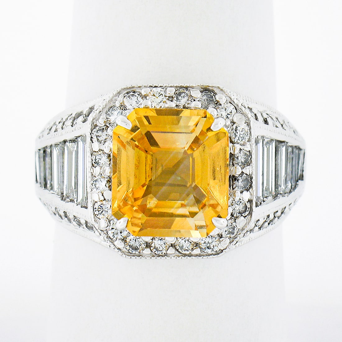 GIA Certified Orangy Yellow Sapphire Diamond 18K White Gold Cocktail Ring: GIA Certified Orangy Yellow Sapphire Diamond 18K White Gold Cocktail Ring This vintage cocktail ring is crafted from solid 18K white gold and features a vivid orangy yellow sapphire as its centerpiece