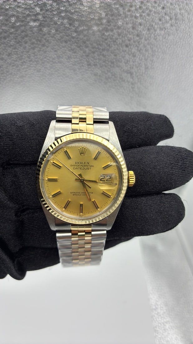 Rolex Datejust 16013 Champagne Stick Dial Aftermarket Jubilee Bracelet: Rolex Datejust 16013 Champagne Stick Dial Aftermarket Jubilee Bracelet This is a Rolex Datejust men's watch featuring a champagne stick dial and a fluted bezel. The watch is paired with an aftermarket