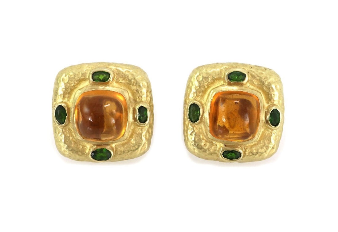 Kanaris 18k Yellow Gold Huggie Earrings with Citrine and Green Tourmaline: Kanaris 18k Yellow Gold Huggie Earrings with Citrine and Green Tourmaline A pair of Kanaris huggie earrings crafted in 18k yellow gold with a hammered square silhouette. They are accented with cabocho