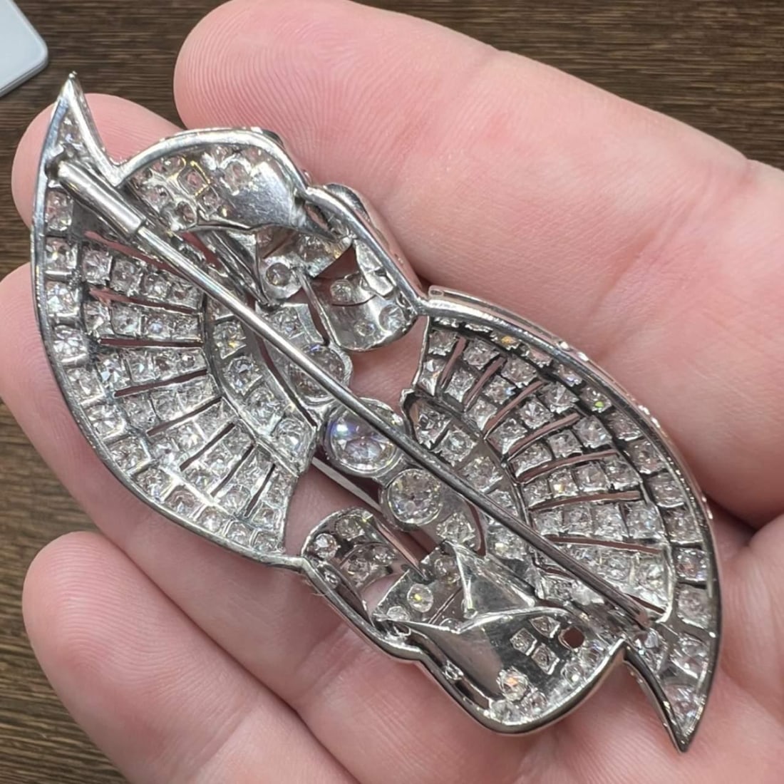 Art Deco Platinum Brooch with 1.10 Ct Diamond: Art Deco Platinum Brooch with 1.10 Ct Diamond This exquisite Art Deco brooch is crafted from platinum and features a stunning central diamond weighing approximately 1.10 Ct. Complementing the centerpi