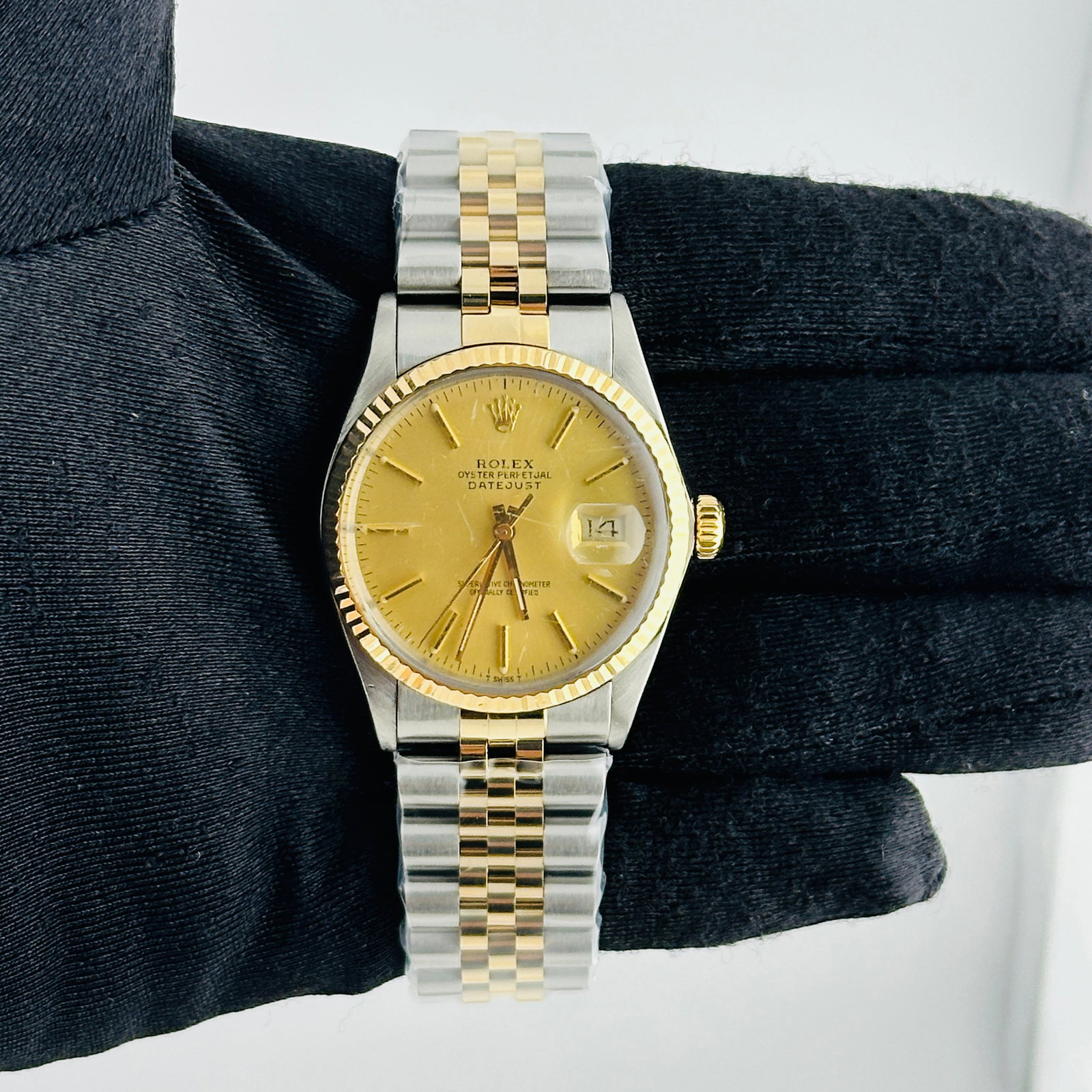 Rolex Datejust 16013 Champagne Stick Dial Aftermarket Jubilee Bracelet: Rolex Datejust 16013 Champagne Stick Dial Aftermarket Jubilee Bracelet This Rolex Datejust features a classic champagne stick dial, complemented by a fluted bezel and mounted on an aftermarket Jubilee