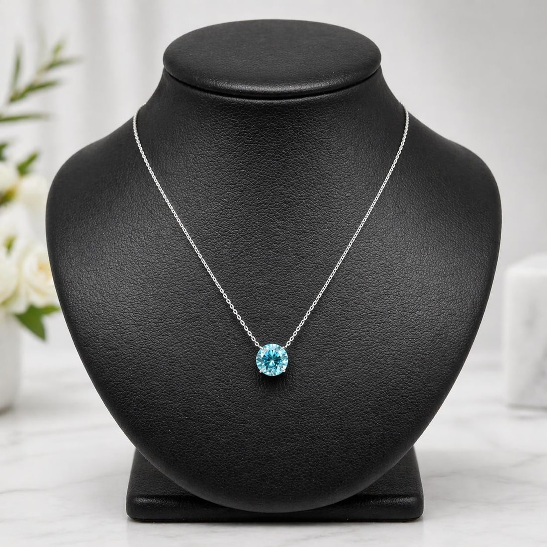 Blue Zircon 14k White Gold Pendant with Adjustable Chain: Blue Zircon 14k White Gold Pendant with Adjustable Chain This unbranded women's pendant necklace features a natural, round brilliant-cut blue zircon weighing 2.38 carats, prong-set in solid 14k white 
