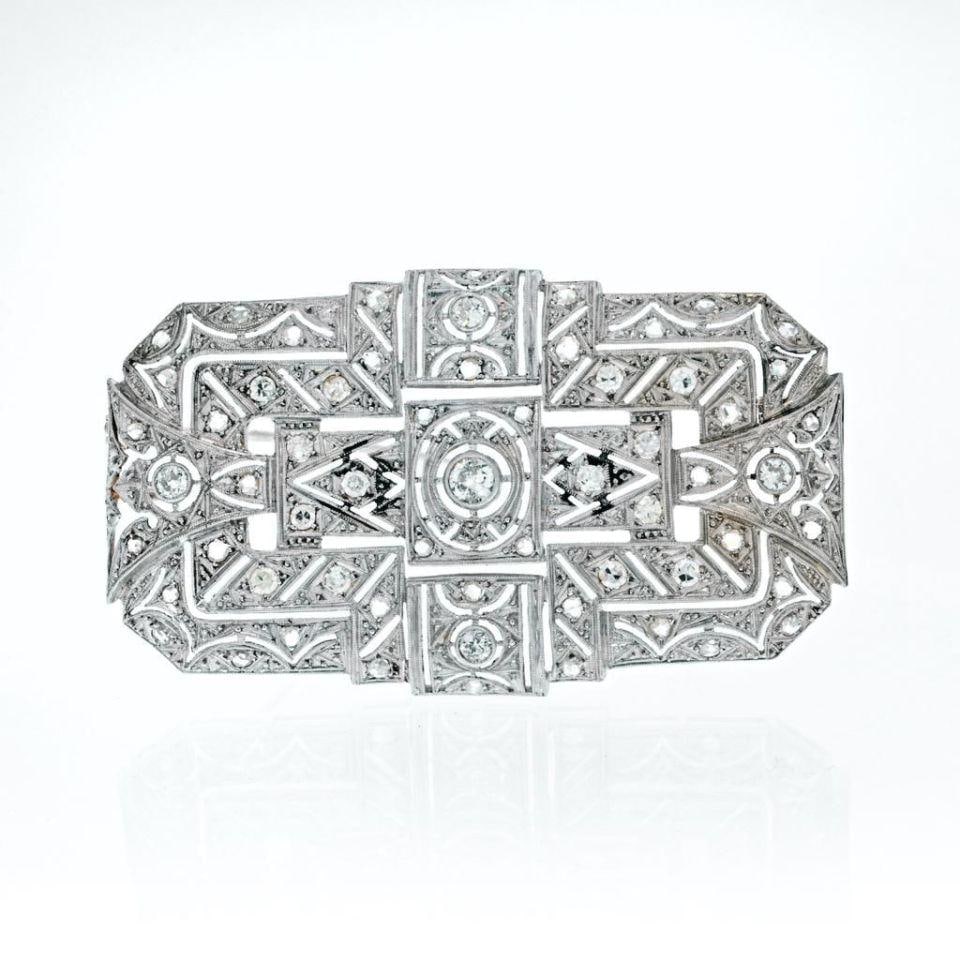 Vintage 1940s 18K White Gold 1.25 Carat Diamond Open Work Brooch: Vintage 1940s 18K White Gold 1.25 Carat Diamond Open Work Brooch This exquisite brooch, crafted in the 1940s, showcases an elegant open work design made from 18K white gold. The rectangular shape feat