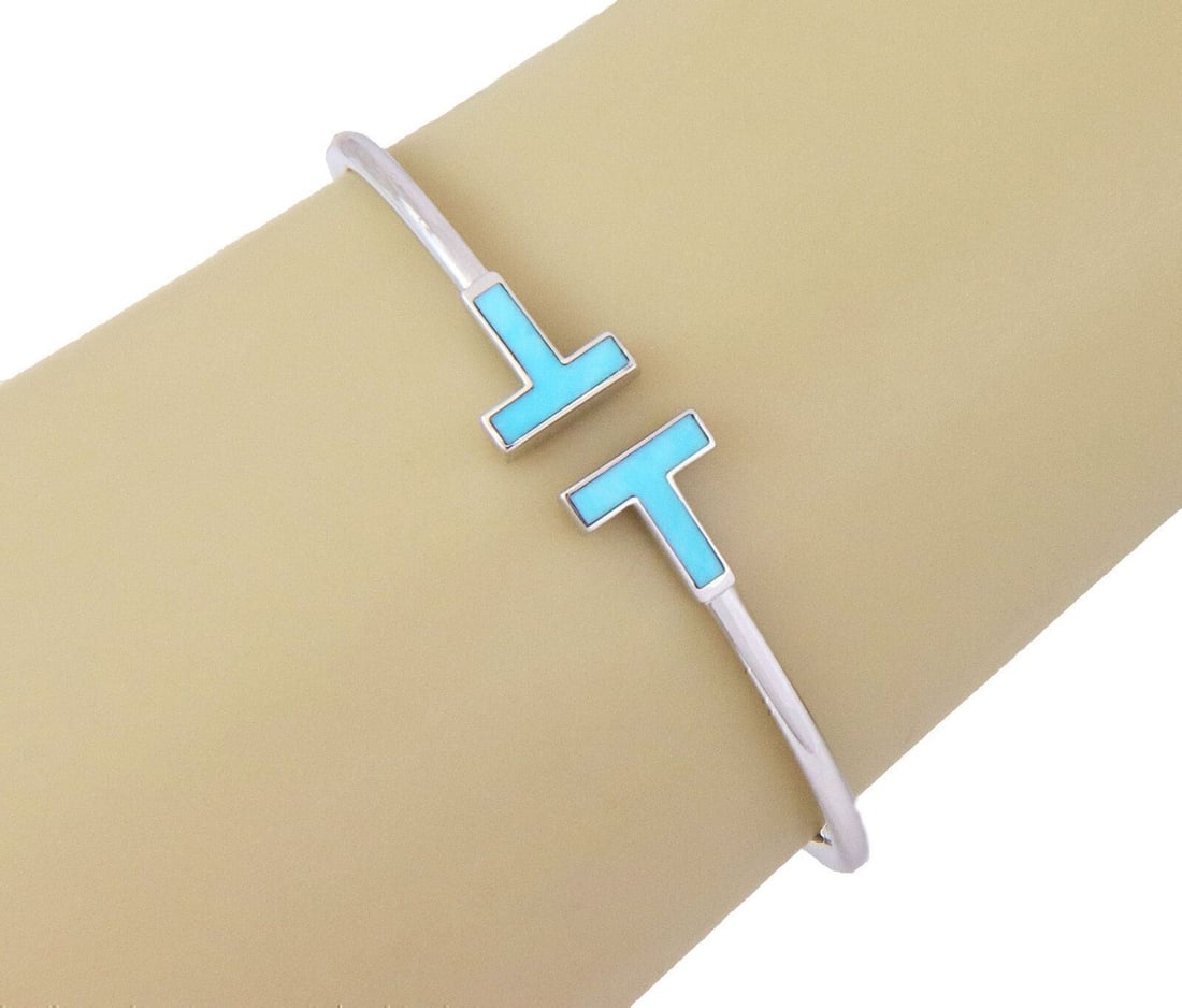 Tiffany & Co. Tiffany T Wire 18k White Gold Turquoise Cuff Bracelet: Tiffany & Co. Tiffany T Wire 18k White Gold Turquoise Cuff Bracelet This Tiffany & Co. Tiffany T Wire turquoise cuff bracelet features the collection's signature open-cuff T Wire design in 18k white g