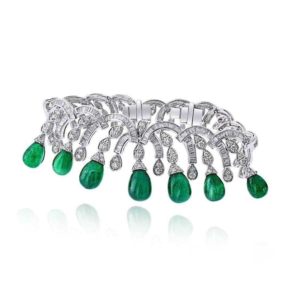 Graff Sugarloaf Emerald and Diamond 18K White Gold Bracelet: Graff Sugarloaf Emerald and Diamond 18K White Gold Bracelet This Graff bracelet is meticulously crafted from 18K white gold and features a sophisticated design with brilliant and baguette-cut diamonds