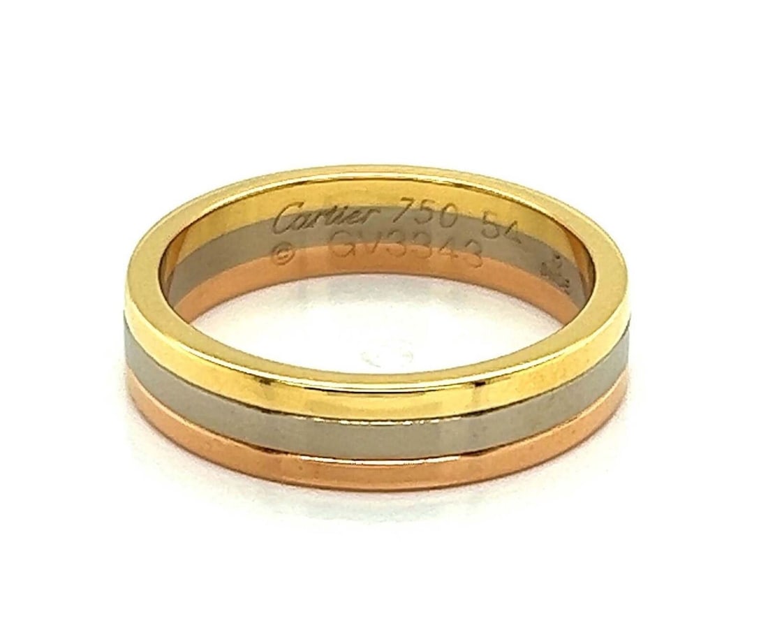 Cartier Vendome Louis tri color 18k gold band ring size 54 with certificate: Cartier Vendome Louis tri color 18k gold band ring size 54 with certificate This Cartier Vendome Louis band ring is crafted in 18k yellow, rose, and white gold with a polished tri-color design. It fea