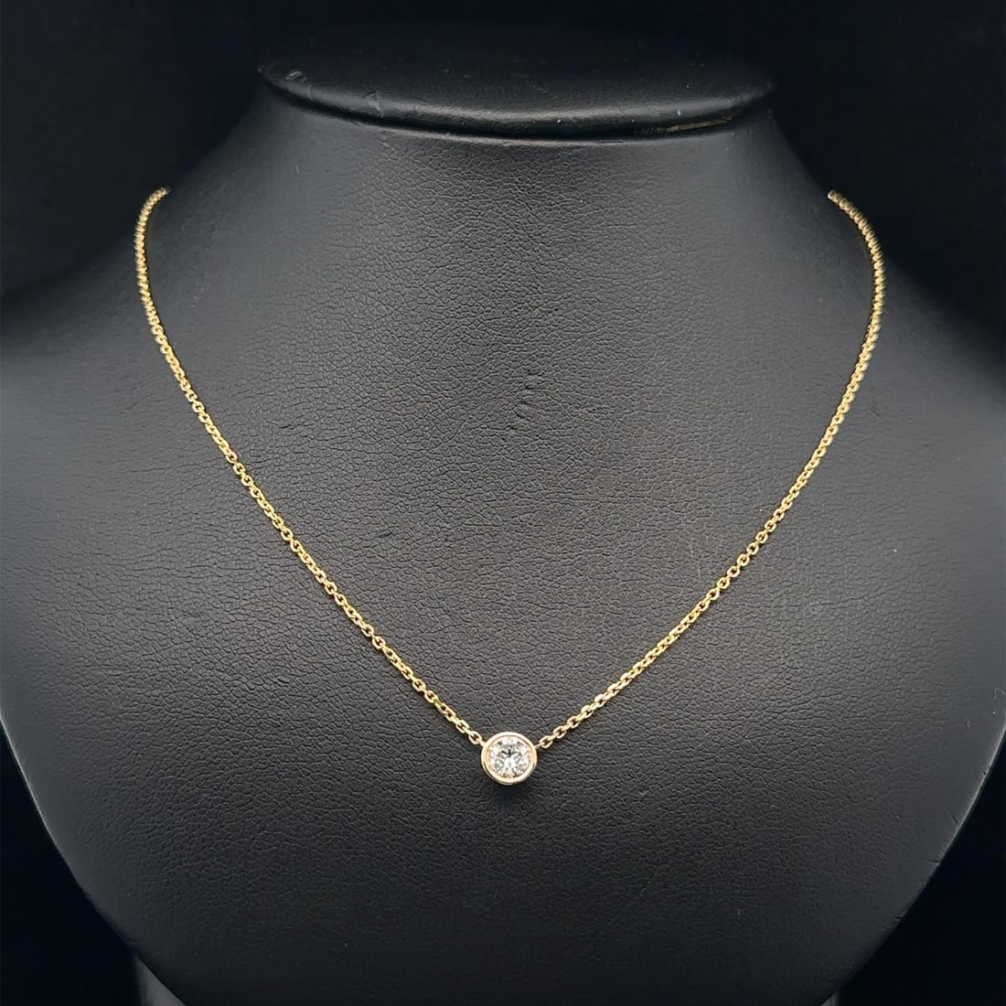0.31ct Diamond Bezel Pendant Necklace in 14k Yellow Gold Adjustable Length: 0.31ct Diamond Bezel Pendant Necklace in 14k Yellow Gold Adjustable Length This un-used necklace features a 0.31 carat natural round brilliant cut diamond set in a bezel setting. Crafted from solid 14
