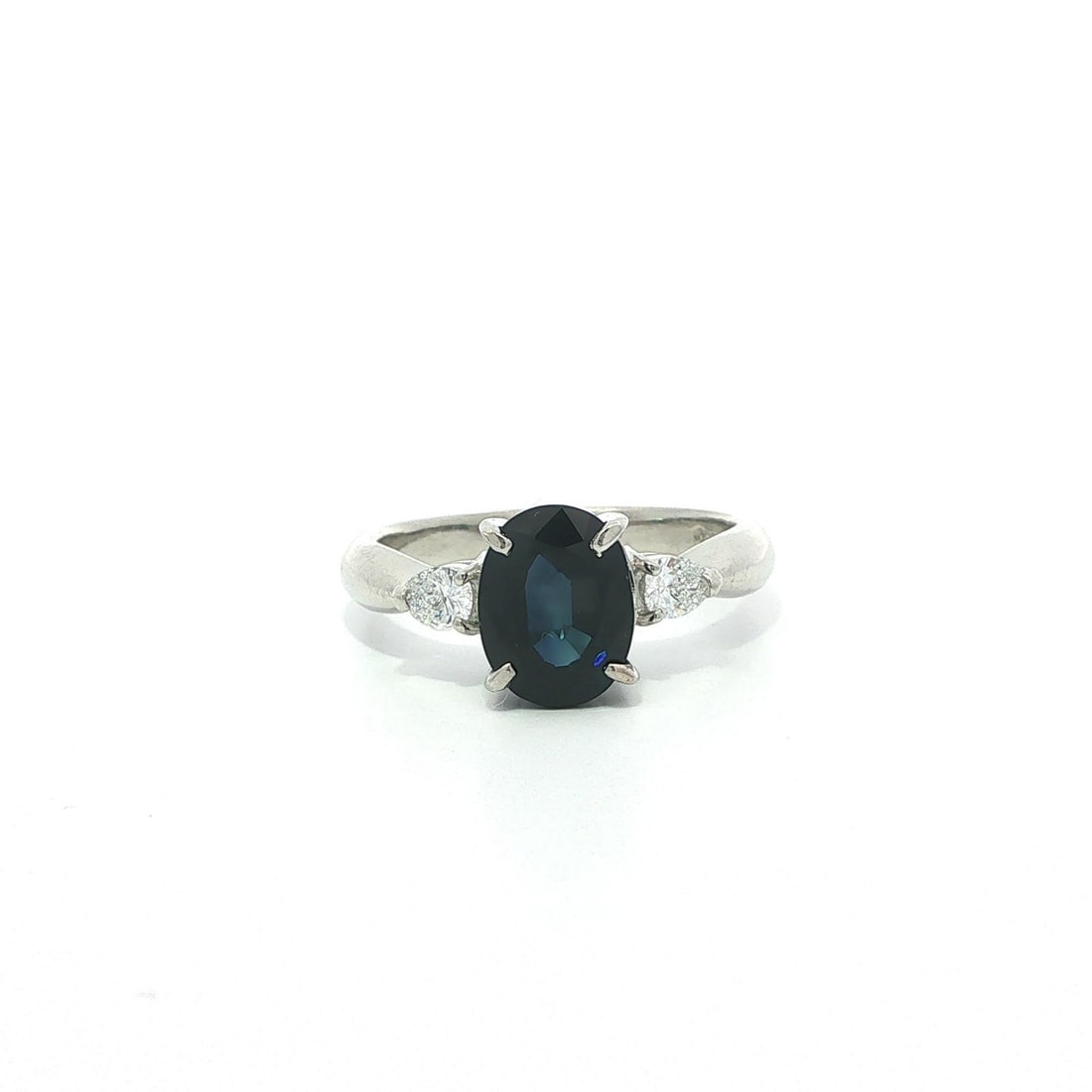 Platinum Oval Sapphire Ring with Pear Diamond Accents Size 7: Platinum Oval Sapphire Ring with Pear Diamond Accents Size 7 This platinum cocktail ring features a striking deep blue, oval-cut natural sapphire as its centerpiece, weighing 2.36 carats. Flanking the
