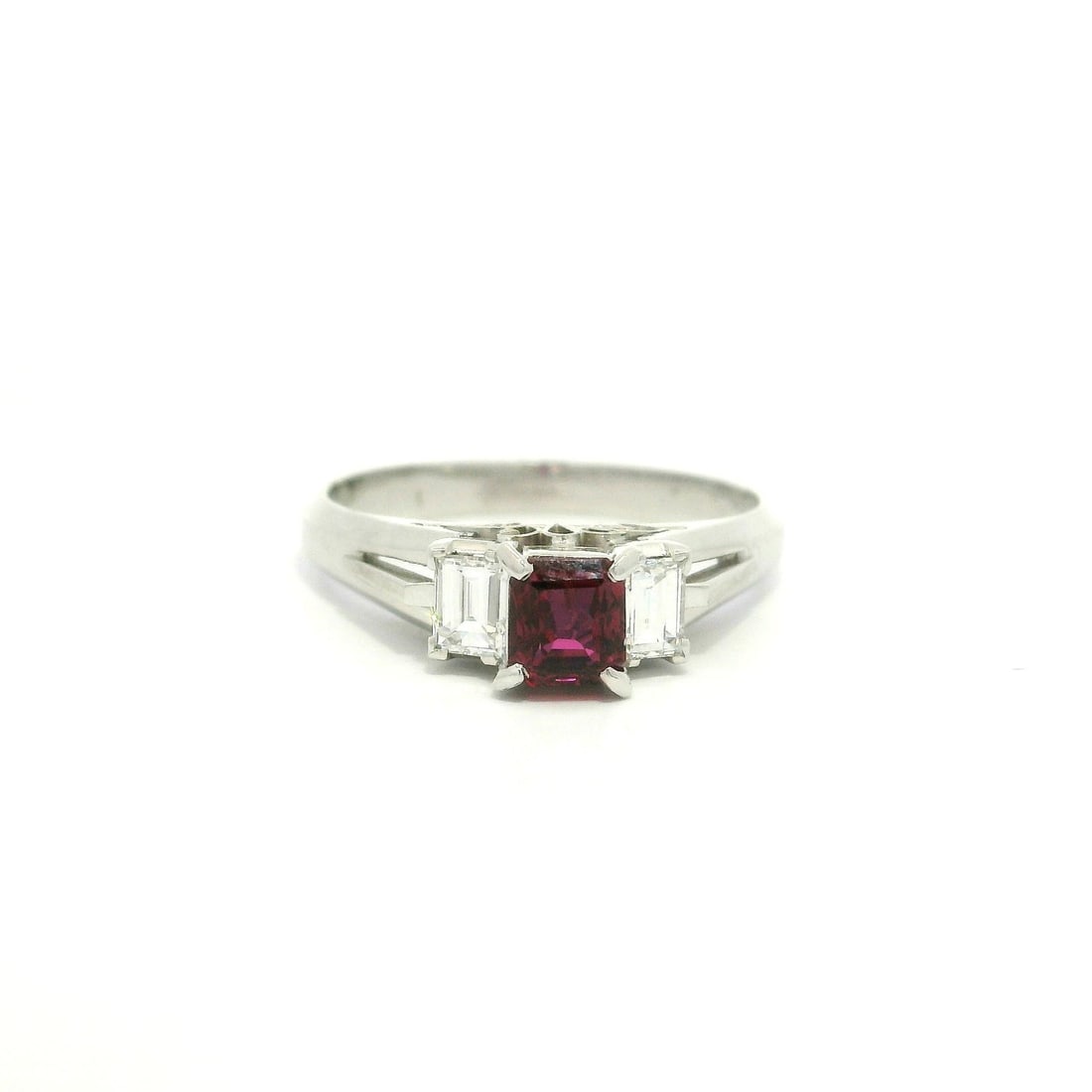 Platinum 0.92ct Square Ruby Ring with Baguette Diamonds: Platinum 0.92ct Square Ruby Ring with Baguette Diamonds This exquisite cocktail ring features a stunning natural square cut ruby at its center, weighing 0.61ct and displaying a deep red hue. Flanking 