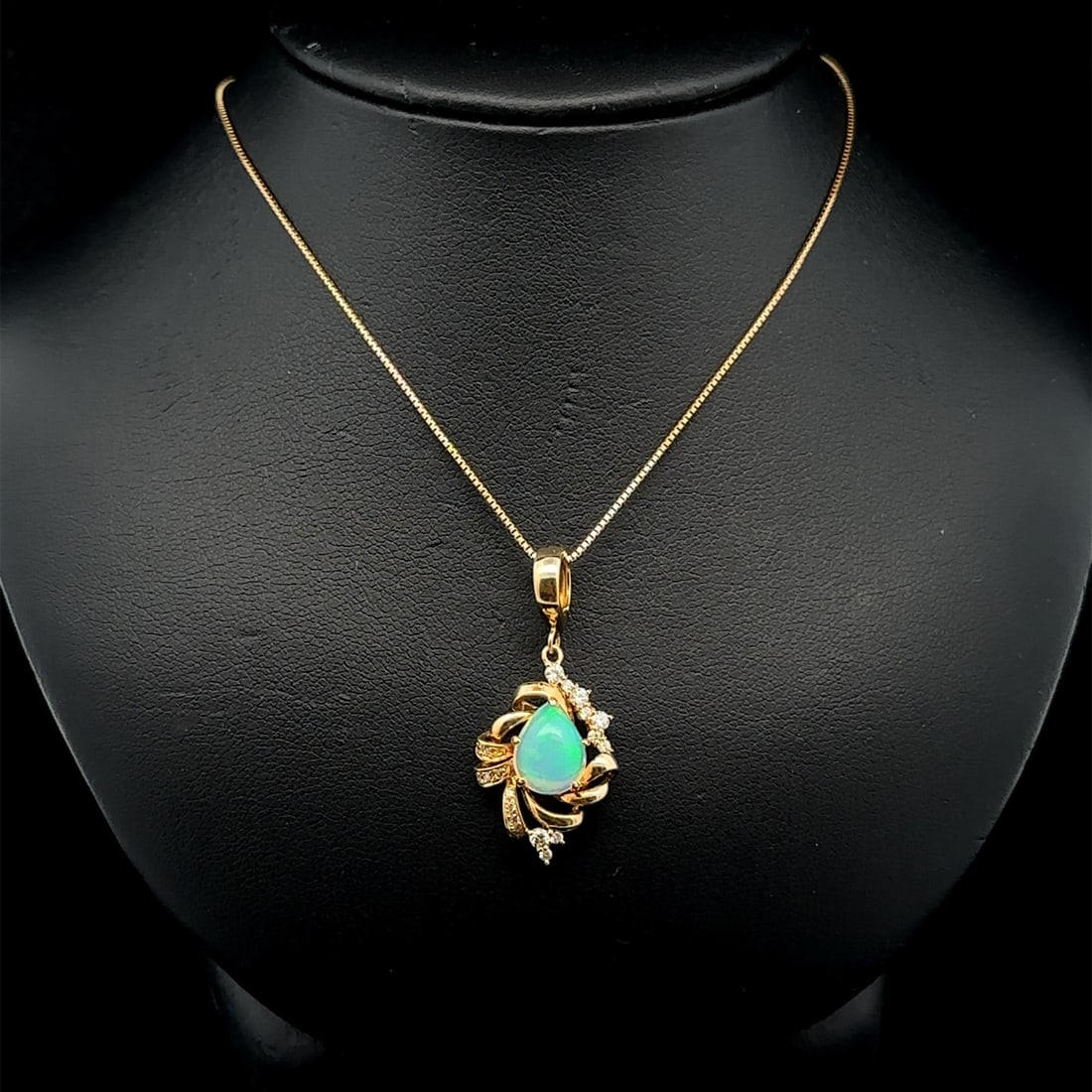 18k Yellow Gold Fire Opal Diamond Teardrop Pendant Necklace: 18k Yellow Gold Fire Opal Diamond Teardrop Pendant Necklace This exquisite necklace features a stunning teardrop pendant crafted from solid 18k yellow gold. It showcases a natural blue fire opal with 