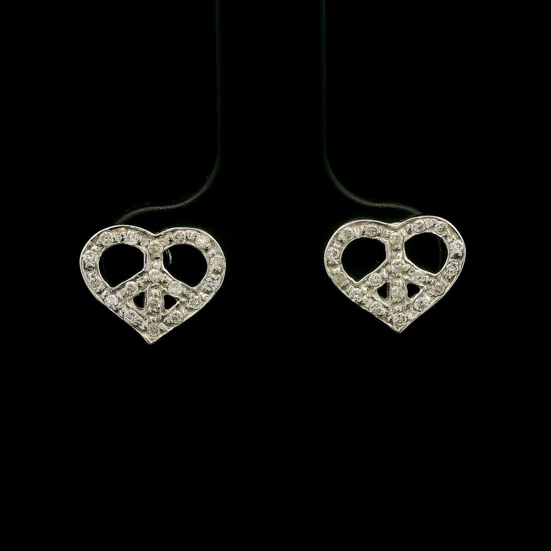 Solid White Gold 0.20ctw Diamond Heart Stud Earrings: Solid White Gold 0.20ctw Diamond Heart Stud Earrings These exquisite stud earrings showcase an open heart design, embodying the themes of peace and love. Crafted from 18K solid white gold, they featur