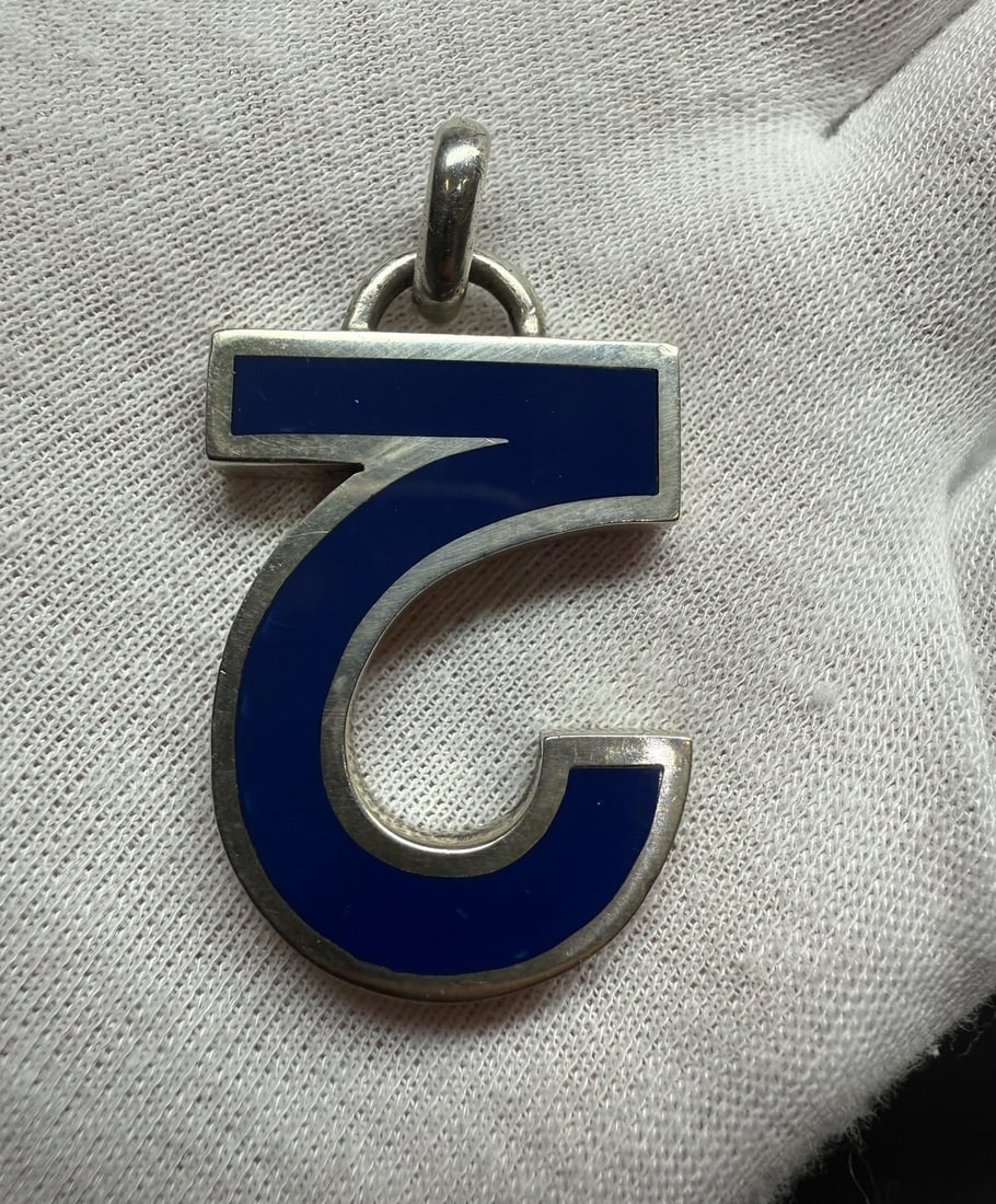 Sterling Silver Capricorn Pendant with Blue Lapis Inlay by Gucci: Sterling Silver Capricorn Pendant with Blue Lapis Inlay by Gucci This vintage Gucci pendant features a custom-cut, natural blue lapis lazuli inlaid in solid sterling silver. The piece showcases the Ca