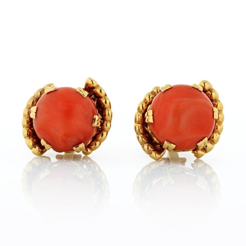 1970s 18K Yellow Gold Round Coral Earrings with Secure Closure: 1970s 18K Yellow Gold Round Coral Earrings with Secure Closure These stunning 1970's earrings feature a beautiful round coral design set in luxurious 18K yellow gold. With a weight of 29.1 grams, they