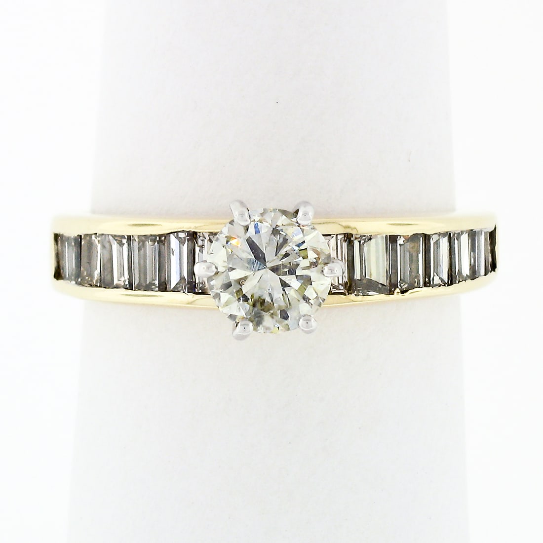 14k Gold 1.41ct Round Diamond Solitaire Baguette Engagement Ring: 14k Gold 1.41ct Round Diamond Solitaire Baguette Engagement Ring This stunning engagement ring features a 14k two-tone gold design, combining solid yellow gold with a white gold basket. At its center,
