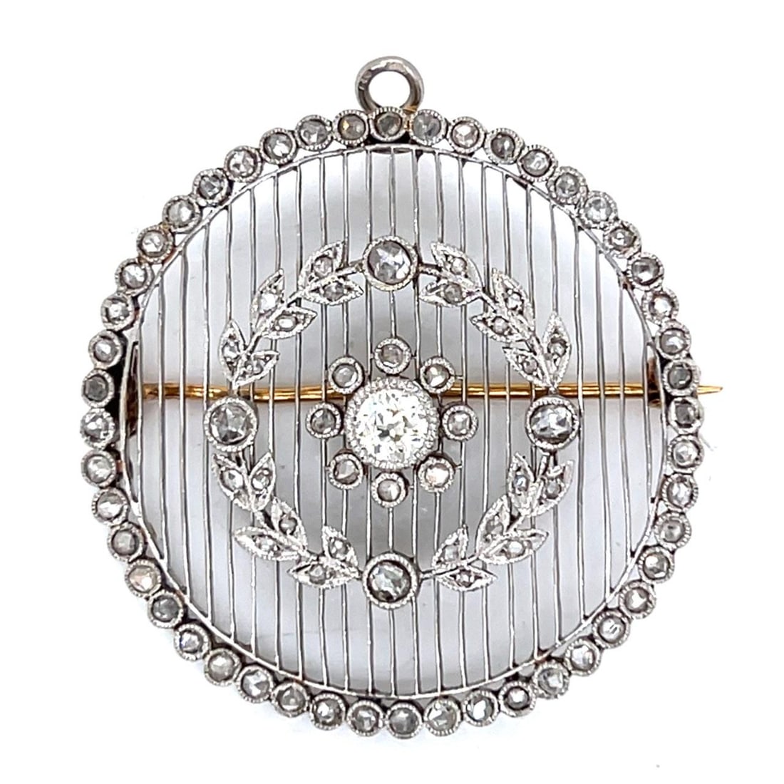 Art Deco Platinum and 18K Gold Diamond Brooch Pendant with Rose Cut Accents: Art Deco Platinum and 18K Gold Diamond Brooch Pendant with Rose Cut Accents This French Art Deco brooch and pendant is crafted from platinum and 18K gold. It features an approximately 0.45 carat cente
