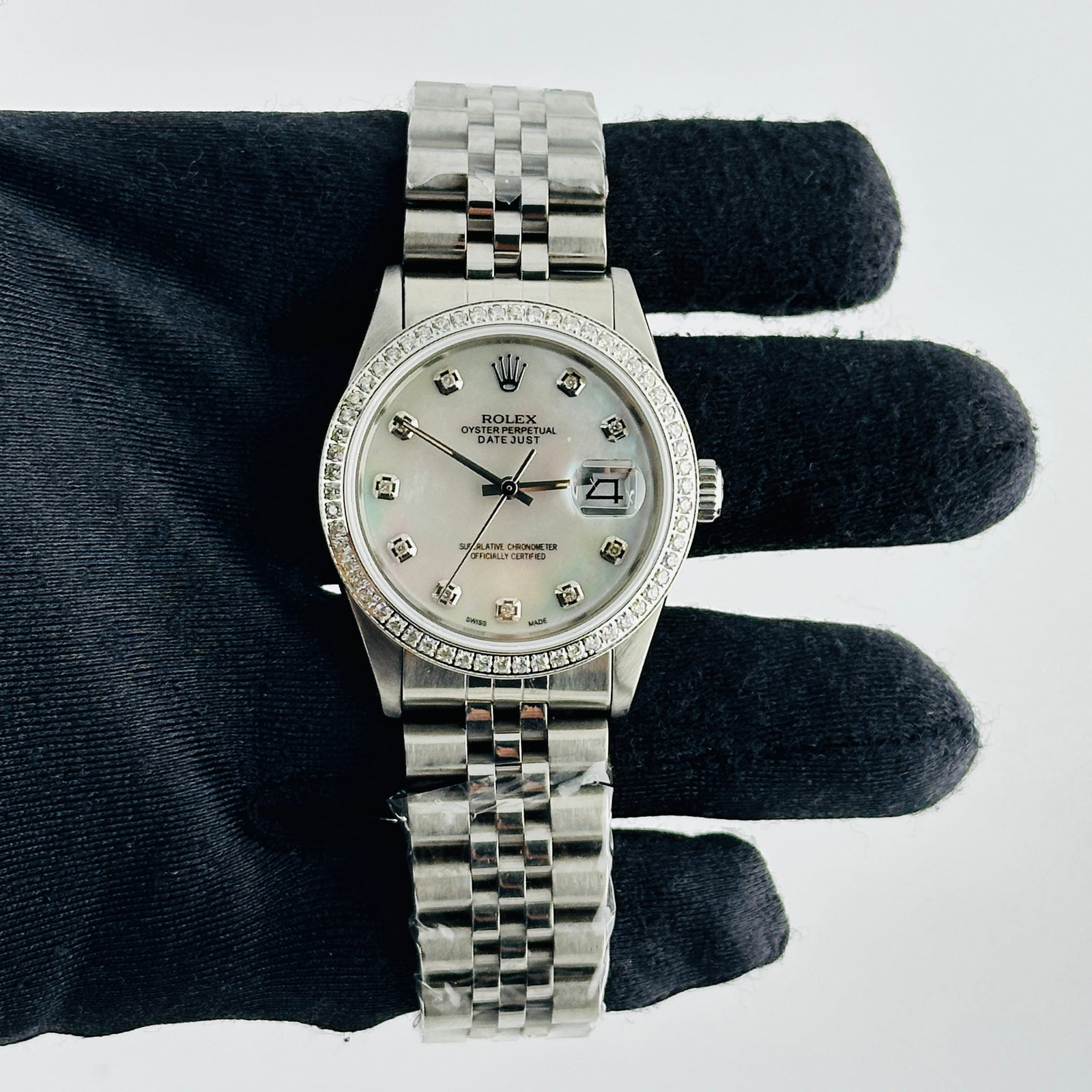 Rolex Datejust aftermarket White MOP Diamond Dial Jubilee Bracelet Ref 16014: Rolex Datejust aftermarket White MOP Diamond Dial Jubilee Bracelet Ref 16014 This men's Rolex Datejust features an aftermarket white mother of pearl diamond dial, an aftermarket pave diamond bezel, an