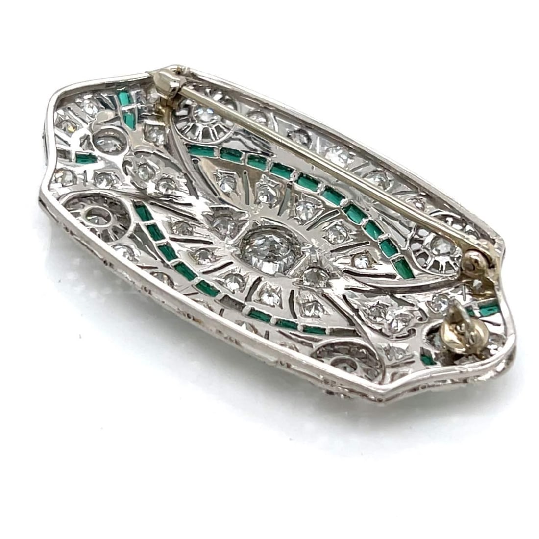 Art Deco Platinum Diamond Brooch Pendant with Synthetic Emeralds: Art Deco Platinum Diamond Brooch Pendant with Synthetic Emeralds This exquisite Art Deco brooch/pendant is crafted in platinum and showcases a stunning central diamond weighing approximately 1.05 Ct. 