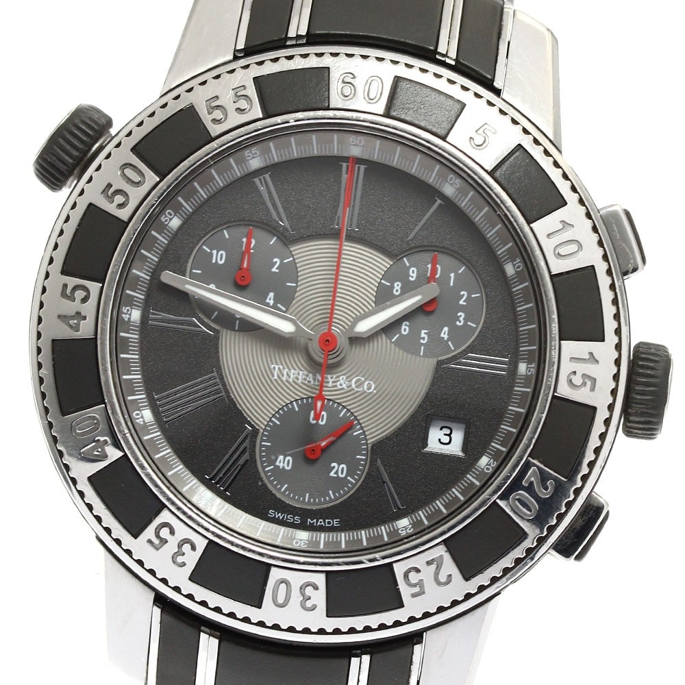 Tiffany Mark T-57 quartz chronograph date men's wristwatch: Tiffany Mark T-57 quartz chronograph date men's wristwatch This pre-owned Tiffany & Co. Mark T-57 men's chronograph wristwatch features a stainless steel and rubber case and bracelet, paired with a gr