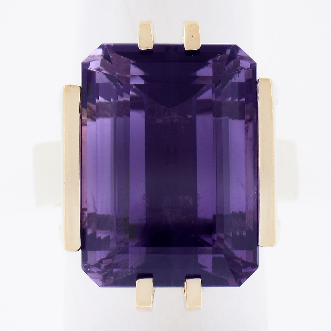 Vintage 14K Yellow Gold 20ct Emerald Cut Amethyst Cocktail Ring: Vintage 14K Yellow Gold 20ct Emerald Cut Amethyst Cocktail Ring This exquisite vintage cocktail ring showcases a stunning natural amethyst in a large emerald cut, measuring approximately 18x13 mm and 