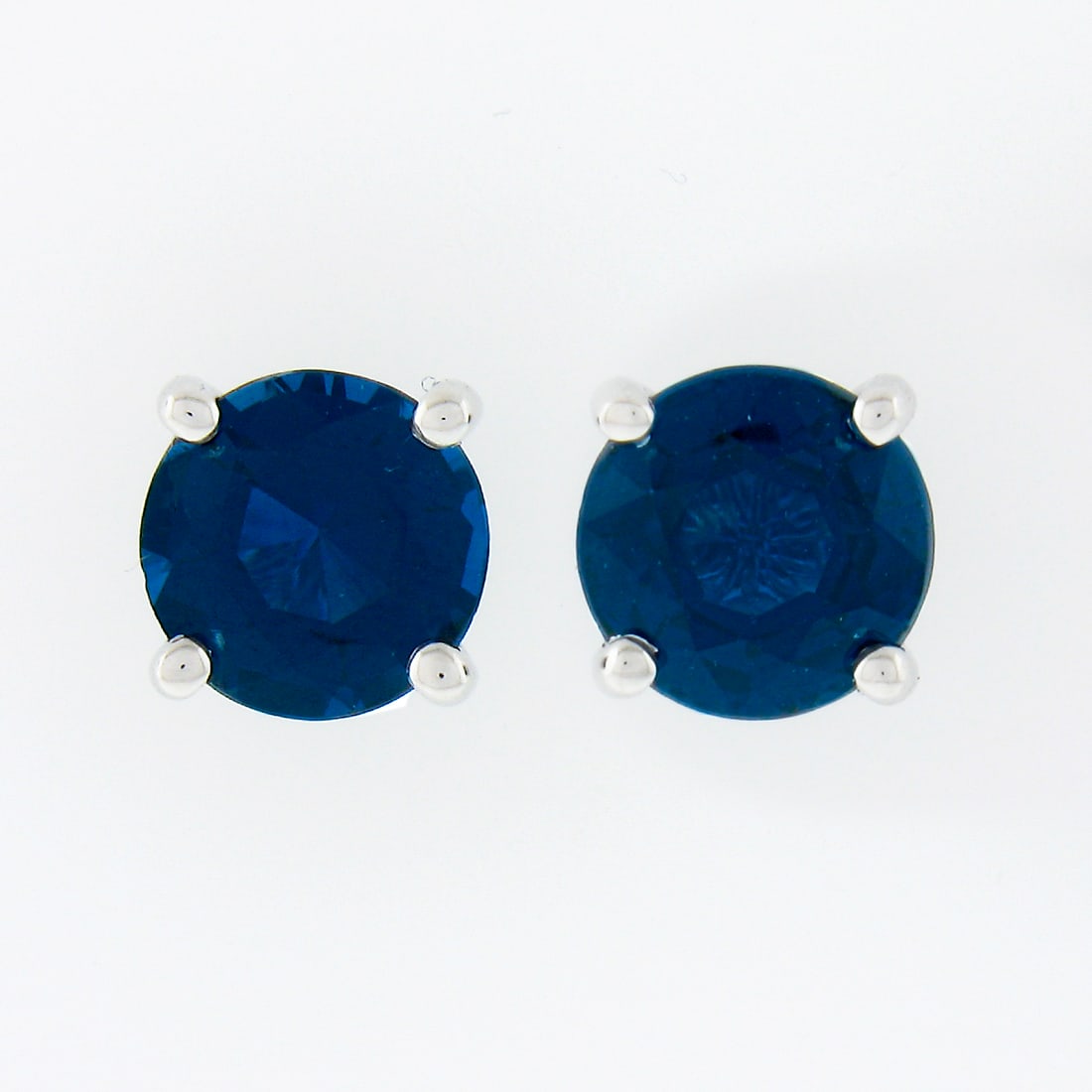 14K White Gold Sapphire Stud Earrings 1.40ctw Round Brilliant Pair: 14K White Gold Sapphire Stud Earrings 1.40ctw Round Brilliant Pair These un-used stud earrings are crafted from solid 14k white gold and feature two natural, round brilliant cut royal blue sapphires. 