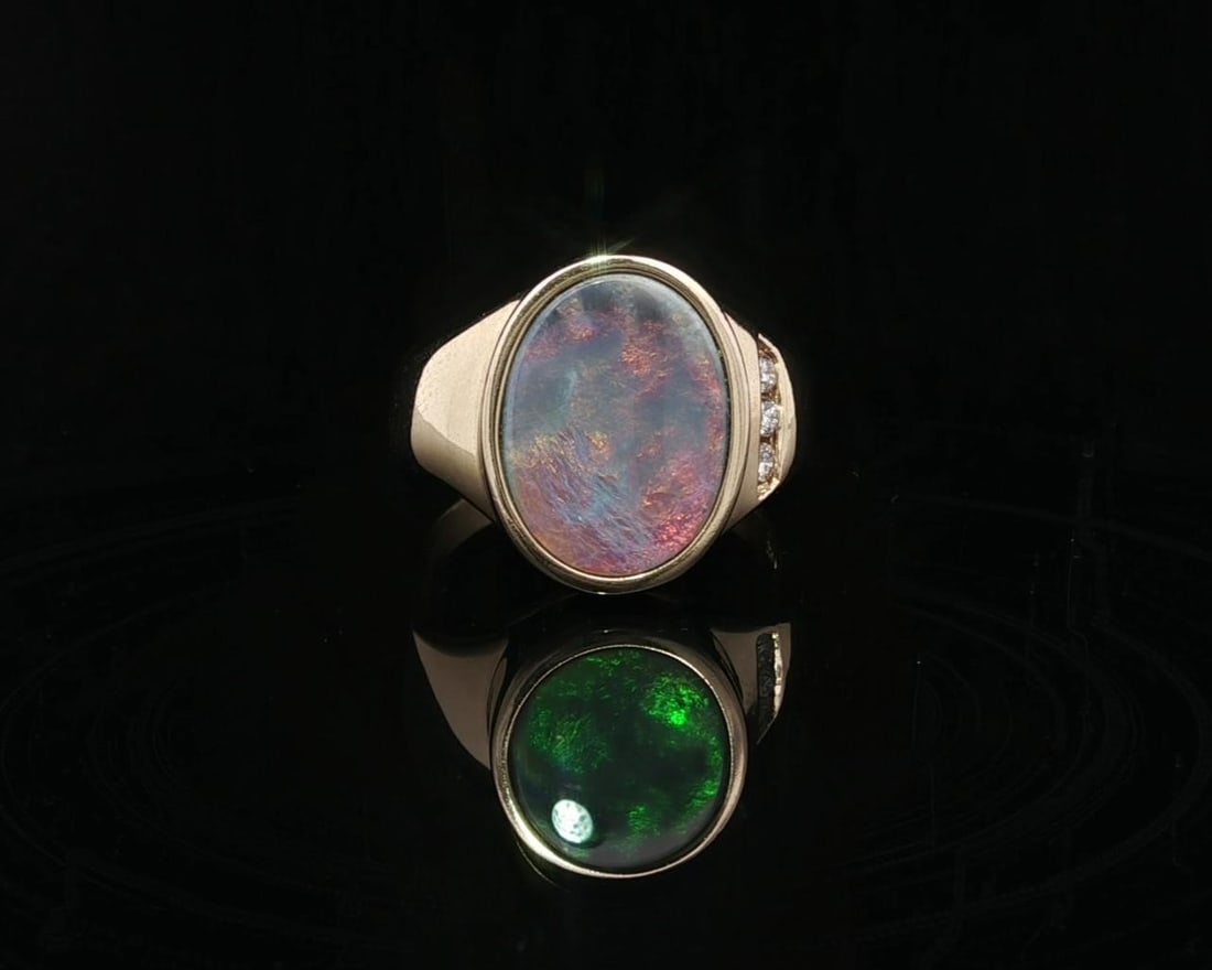 14k Yellow Gold Opal and Diamond Band Ring Size 7.5: 14k Yellow Gold Opal and Diamond Band Ring Size 7.5 This exquisite band ring features a stunning natural boulder opal, set in a secure oval bezel. The opal showcases a captivating play of color, with 