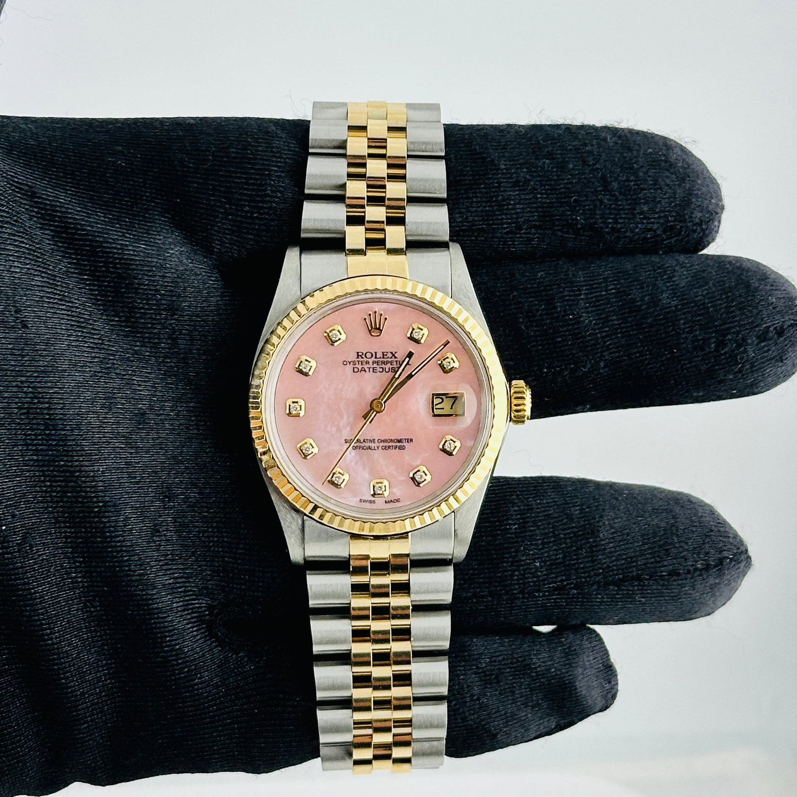 Rolex Datejust 16013 Mens Watch Aftermarket Jubilee Pink MOP Dial: Rolex Datejust 16013 Mens Watch Aftermarket Jubilee Pink MOP Dial This Rolex Datejust features a champagne linen dial, fluted bezel, and an aftermarket Jubilee bracelet. The watch is designed for men 