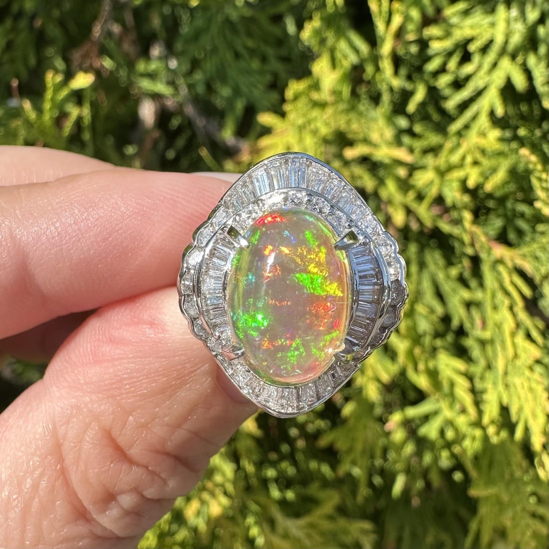 Platinum Jelly Opal Cocktail Ring with Baguette Diamonds Size 5.5: Platinum Jelly Opal Cocktail Ring with Baguette Diamonds Size 5.5 This elegant cocktail ring features a vibrant 3.73 carat natural jelly opal in an oval cabochon cut, prong set to display its fiery or