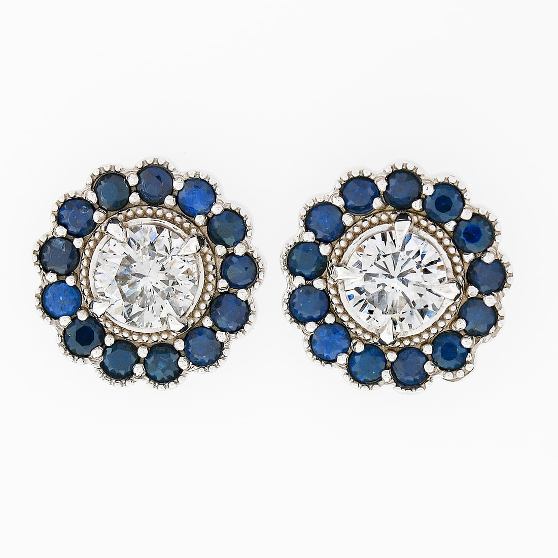14k White Gold 1.51ct Diamond Sapphire Flower Cluster Earrings: 14k White Gold 1.51ct Diamond Sapphire Flower Cluster Earrings Elevate your style with these stunning 14k White Gold earrings featuring a beautiful flower cluster design. Each earring showcases a roun