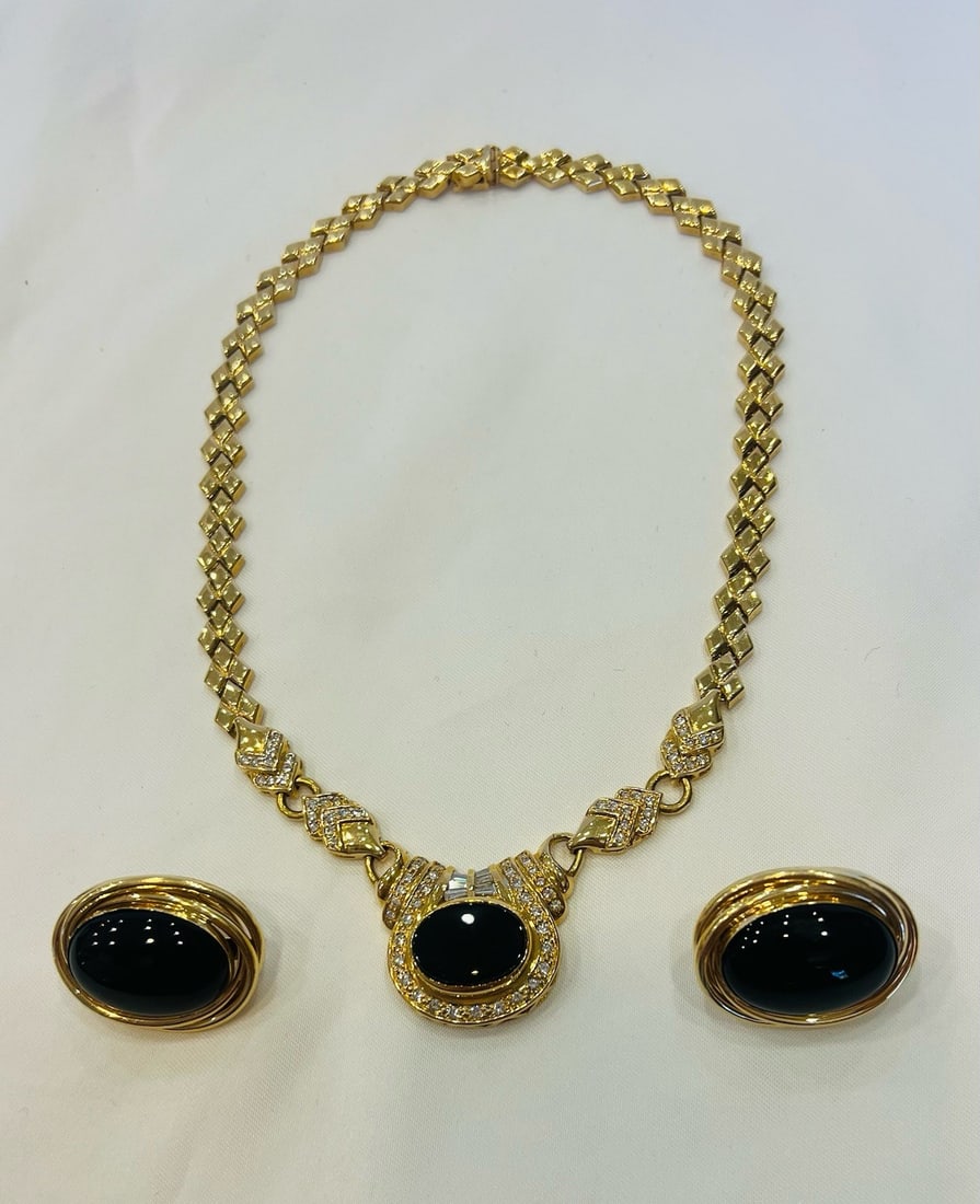 14k Yellow Gold Onyx Diamond Necklace and Earrings Set: 14k Yellow Gold Onyx Diamond Necklace and Earrings Set This stunning set features a necklace and matching pair of earrings crafted from 14k yellow gold, onyx, and diamonds. The necklace showcases intr