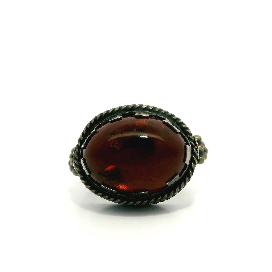 Vintage Handmade Sterling Silver Amber Cabochon Cocktail Ring: Vintage Handmade Sterling Silver Amber Cabochon Cocktail Ring This exquisite vintage handmade cocktail ring showcases a stunning natural amber cabochon as its centerpiece. The oval cabochon, measuring