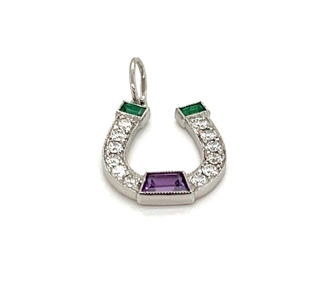 Tiffany & Co. Horseshoe Pendant in Platinum with Diamond Emerald Amethyst: Tiffany & Co. Horseshoe Pendant in Platinum with Diamond Emerald Amethyst This pre-owned Tiffany & Co. charm pendant features a horseshoe motif and is crafted in platinum. It is accented with diamonds