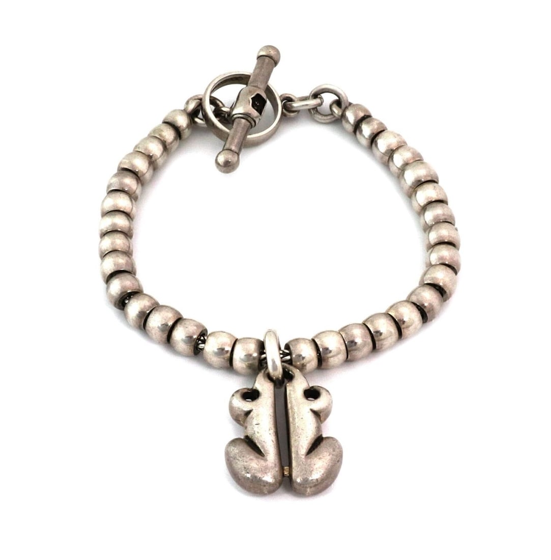 Kieselstein-Cord Sterling Silver Beaded Bracelet with Frog Toggle Charm: Kieselstein-Cord Sterling Silver Beaded Bracelet with Frog Toggle Charm This vintage Kieselstein-Cord bracelet is crafted in sterling silver and features a beaded link design accented by a frog charm 