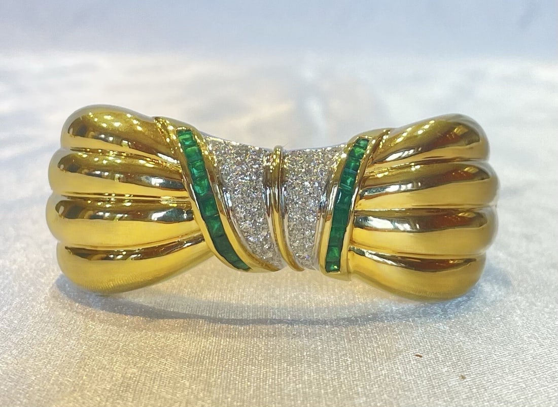 GJ French 18K Gold Diamond Emerald Cuff Bracelet: GJ French 18K Gold Diamond Emerald Cuff Bracelet This exquisite French cuff bracelet is crafted from 18K yellow gold, showcasing a stunning combination of diamond and emerald stones. Purchased in Pari