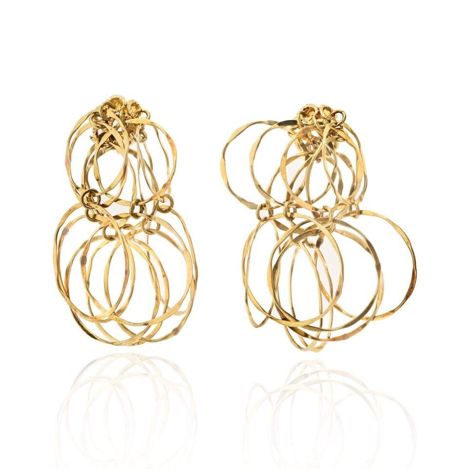 1970s Cascade Earrings in 18K Yellow Gold by Cartier: 1970s Cascade Earrings in 18K Yellow Gold by Cartier These vintage Cartier earrings from the 1970s are crafted in 18K yellow gold and feature a unique cascading design of hammered hoops connected by r