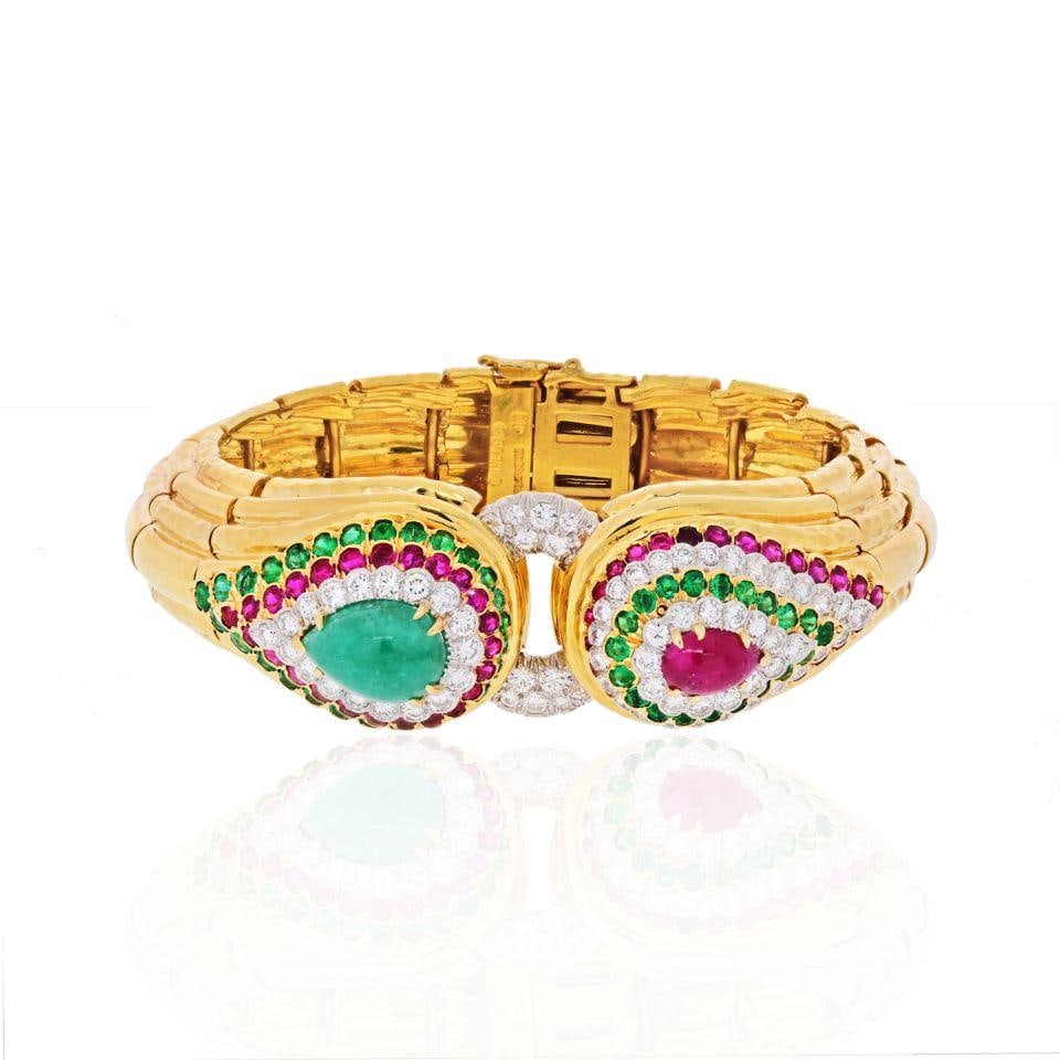 David Webb 1969 Platinum 18K Gold Bracelet with Emeralds and Rubies: David Webb 1969 Platinum 18K Gold Bracelet with Emeralds and Rubies Elevate your collection with this exquisite David Webb bracelet, a stunning piece that showcases a unique buckle design. Crafted fro