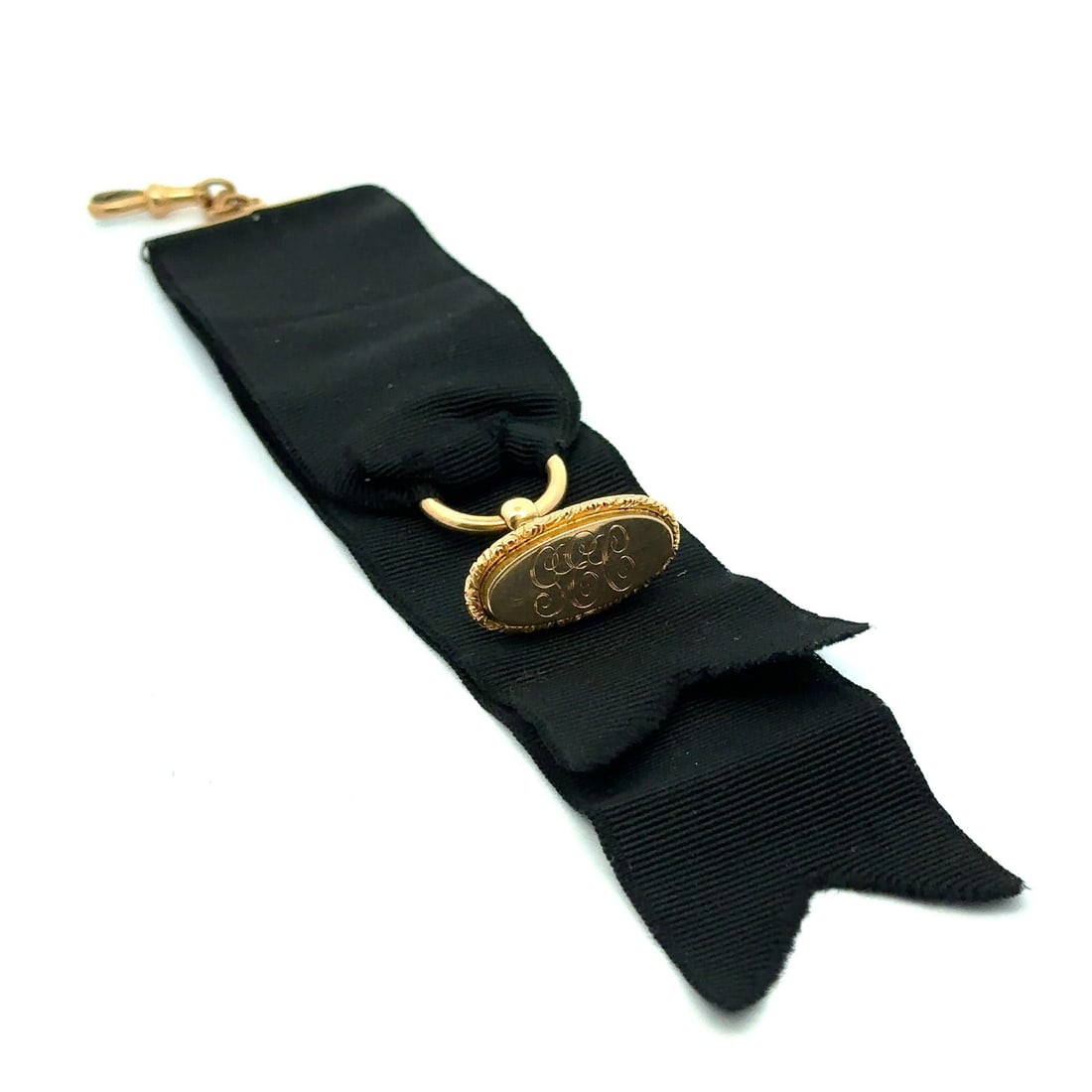 Antique Victorian 14k Yellow Gold GEC Fob Clip on Black Ribbon: Antique Victorian 14k Yellow Gold GEC Fob Clip on Black Ribbon This exquisite Antique Victorian fob vest clip features a stunning monogrammed 'GEC' design, elegantly crafted in 14k yellow gold. The it