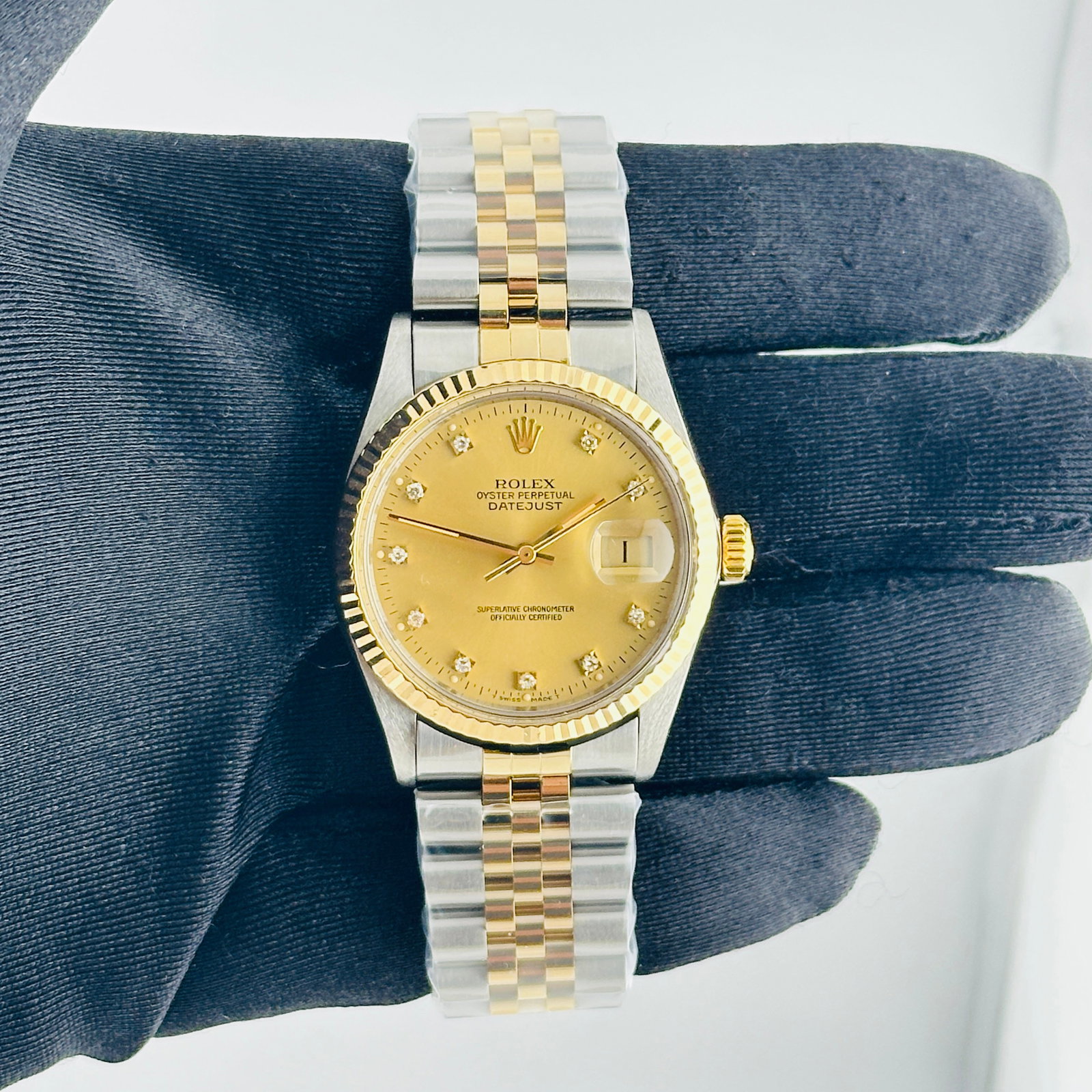 Rolex Datejust 16013 Champagne Diamond Dial Aftermarket Jubilee Bracelet: Rolex Datejust 16013 Champagne Diamond Dial Aftermarket Jubilee Bracelet This Rolex Datejust features a champagne diamond factory dial, complemented by a fluted bezel and an aftermarket Jubilee bracel