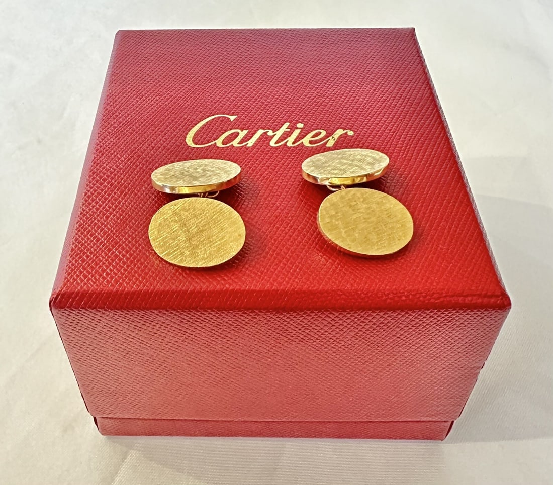 Cartier 14k Yellow Gold Cufflinks with Original Box: Cartier 14k Yellow Gold Cufflinks with Original Box Elevate your formal attire with this exquisite pair of cufflinks from Cartier, crafted in 14k yellow gold. Each cufflink features an elegant oval de