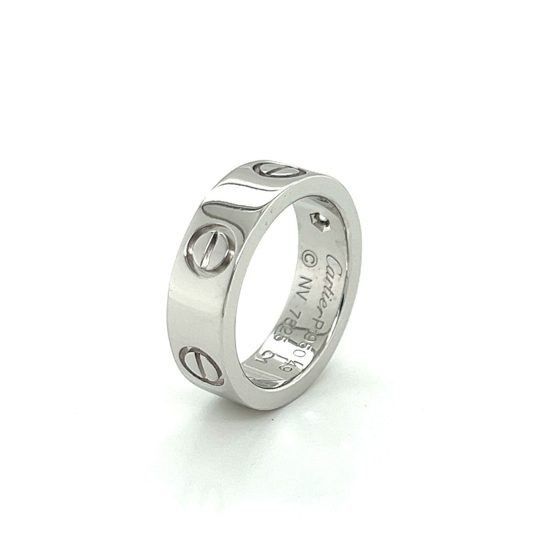 Cartier Love Platinum Diamond Band Ring 5.5mm Size 4.5: Cartier Love Platinum Diamond Band Ring 5.5mm Size 4.5 A Cartier Love diamond band ring crafted in platinum, featuring the classic Love collection design with a single diamond accent. The ring is size